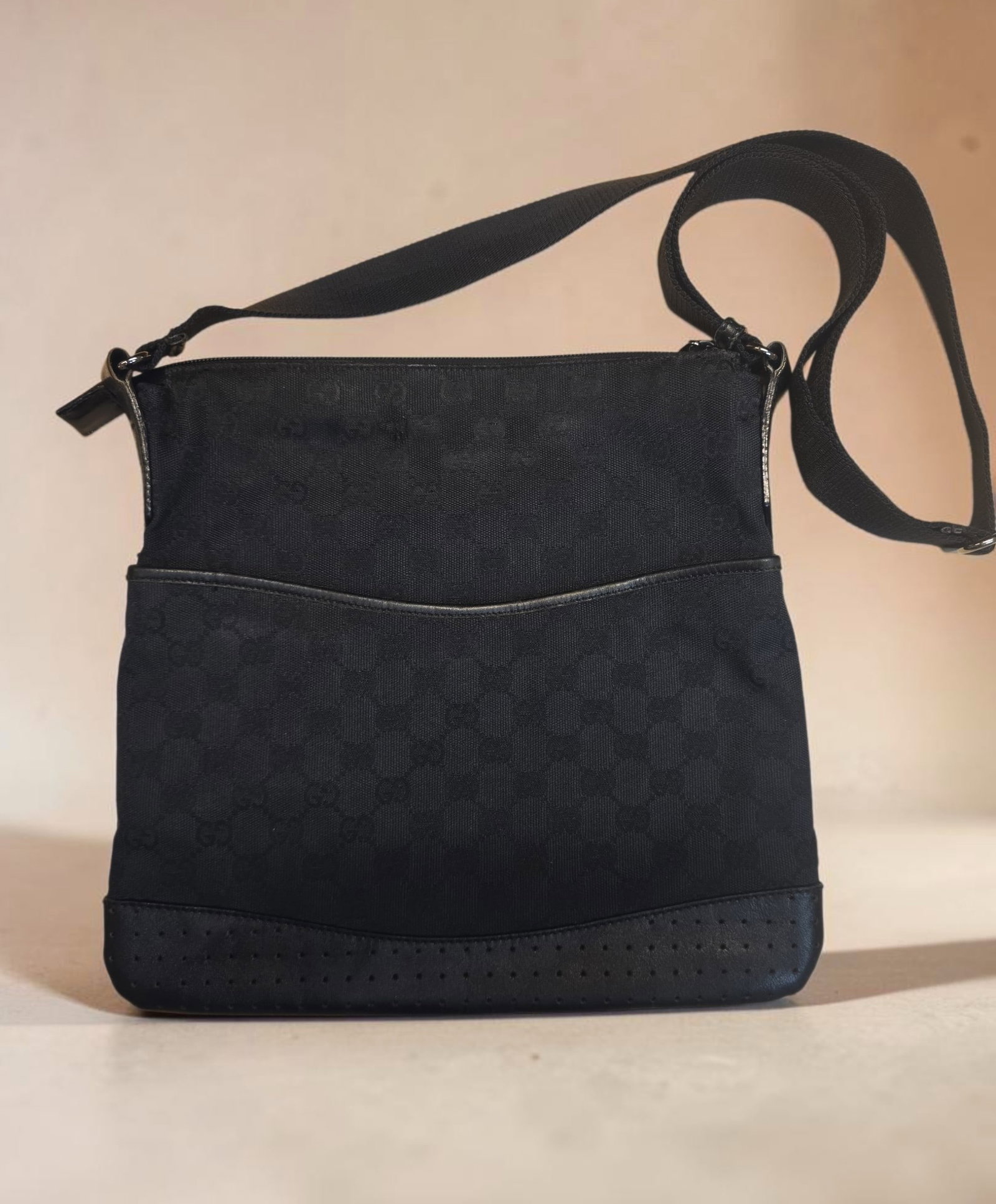 Authentic Gucci GG Monogram perforated leather trim messenger bag: 11.75" x 11.25" Authentic Gucci GG Monogram perforated leather trim messenger bag, This stylish messenger bag is crafted of classic Gucci GG monogram canvas in black. This features adjustable