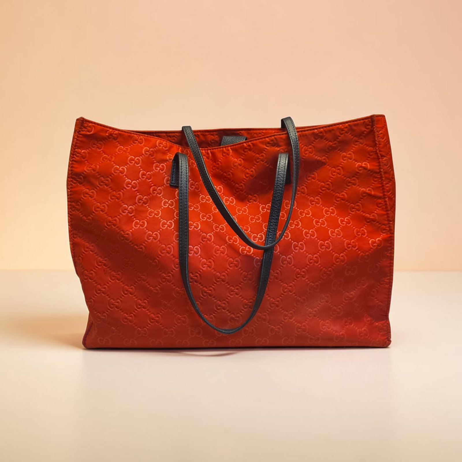 Authentic Gucci Red GG Nylon Tote Bag: 14.75" x 12.25" x 4.5" Authentic Gucci Red GG Nylon Tote Bag, Covered in a tonal, embossed version of the iconic interlocking GG monogram pattern, great used condition