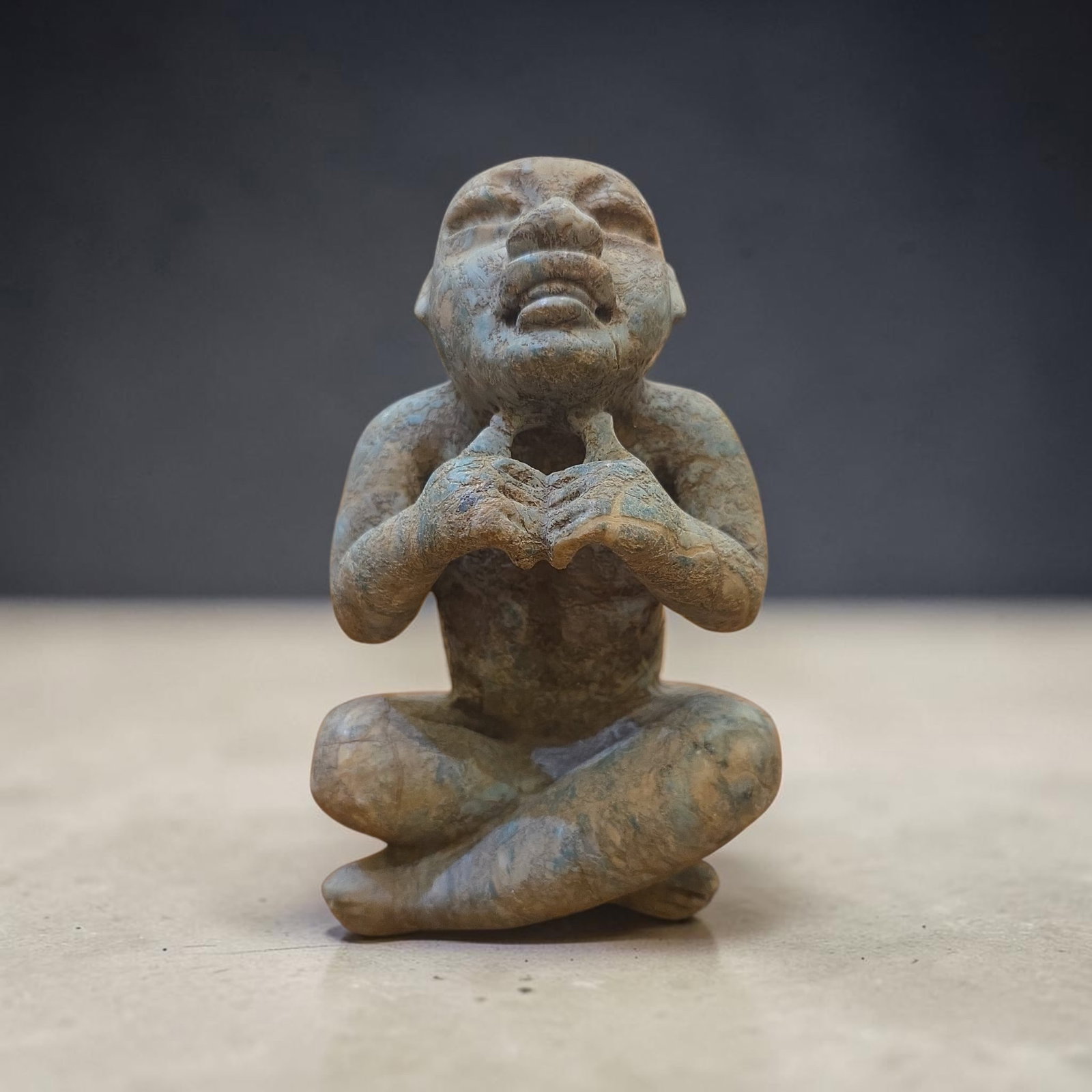Pre-Columbian Olmec Seated Figure: 5.75" x 5", Pre-Columbian Olmec Seated Figure, Heavy Patina, Carved Green Stone, Almond Shaped Eyes, Down-Turned Snarl Mouth, Transformation Seated Figure with Cross Legged Stance, Olmec Culture