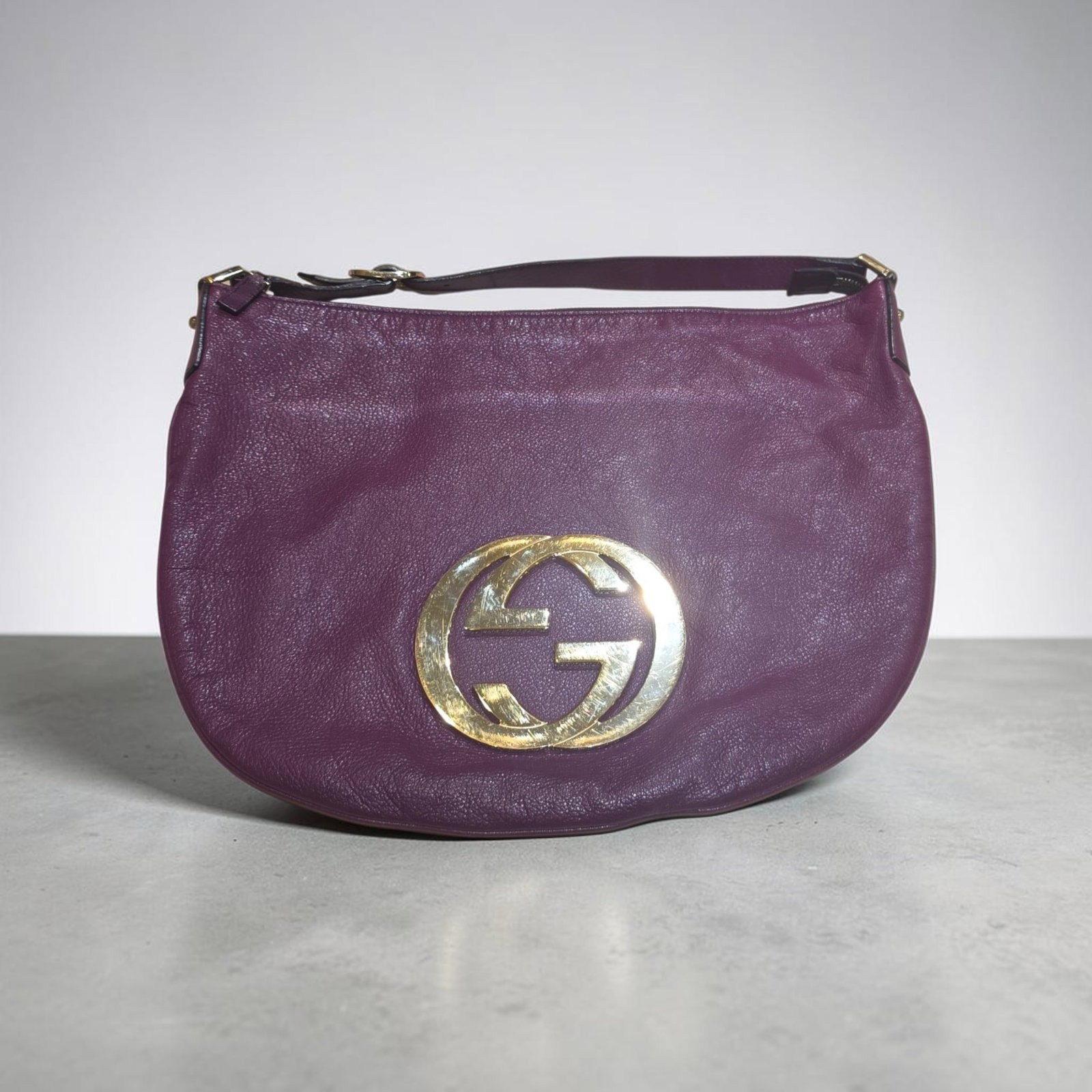 Authentic Gucci Plum Leather Interlocking G Blondie Hobo Bag: 11.25" x 14" Authentic Gucci Plum Leather Interlocking G Blondie Hobo Bag, Lambskin Leather, Shows Sign of Wear on Interlocking G, Handbag is in Excellent Condition