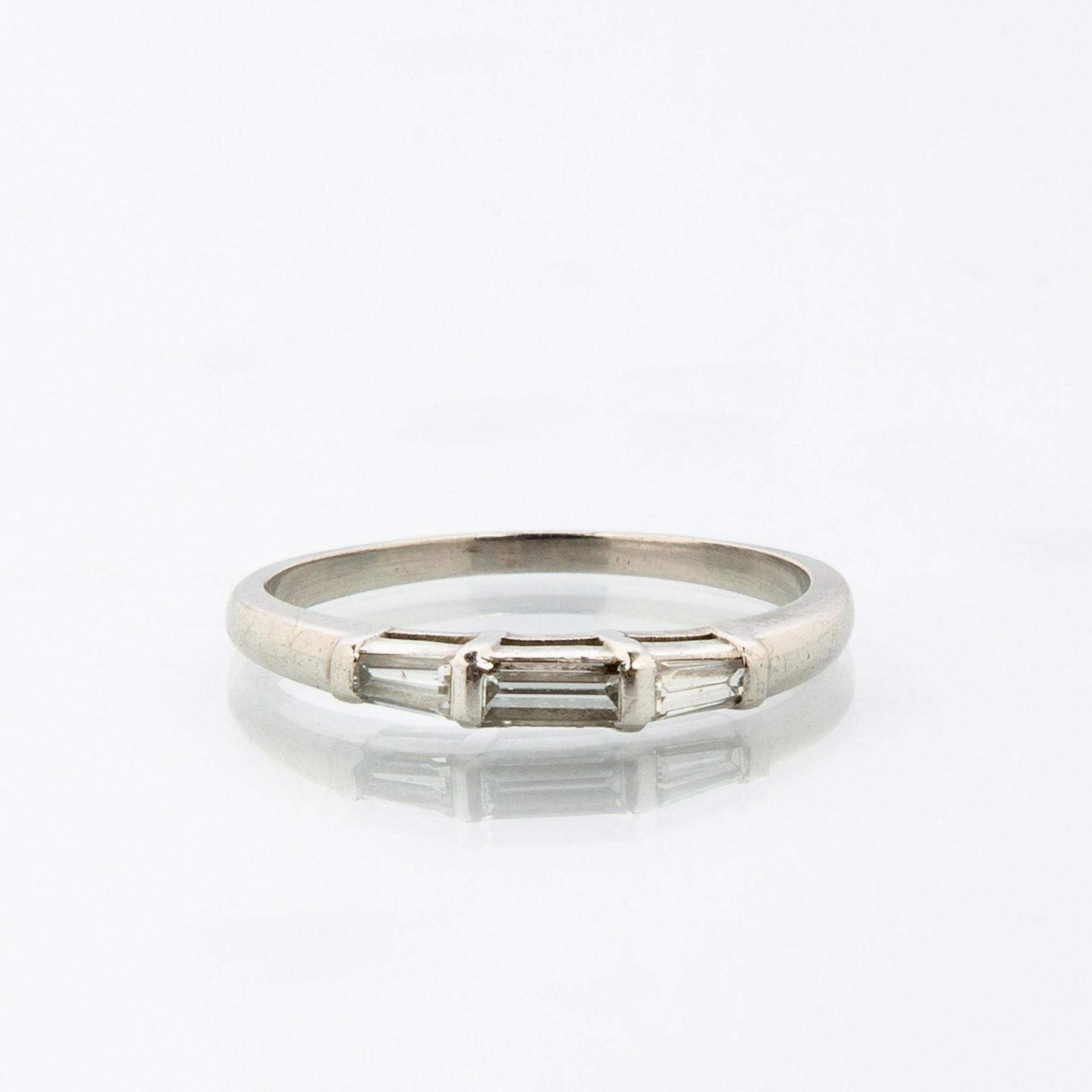 Platinum and Diamond Baguette Wedding Band: Platinum and Diamond Baguette Wedding Band, Marked on inner shank "10%IRIDPLAT", classic design with center straight baguette flanked by two tapered baguettes, ring size 7 1/4 and a total weight of 3.
