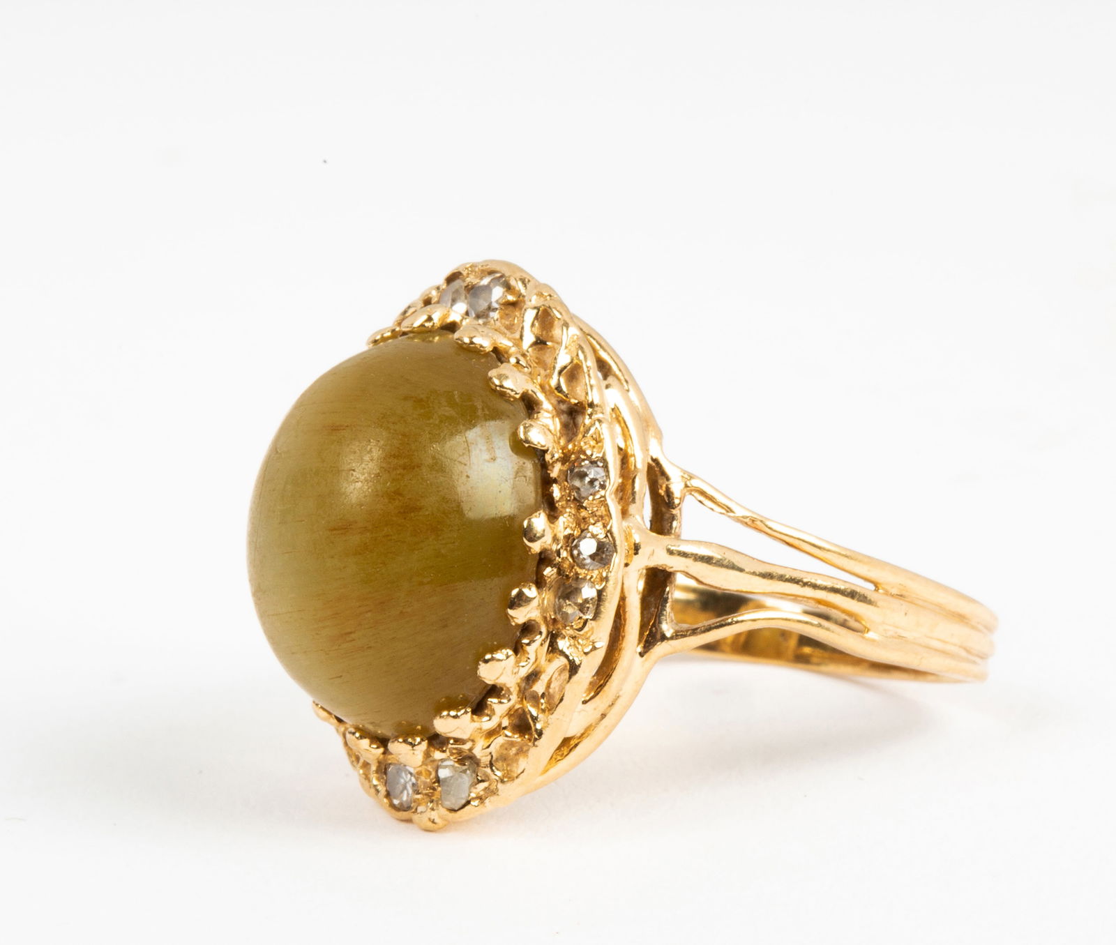 A Vintage Cat's Eye, Yellow Gold and Diamond Ring: Yellow gold wire construction with eight old cut diamonds, two at each side and three at top and bottom, the center cabochon cat's eye measures approx. 14mm x 12mm x 7.26mm, it shows surface scuffs an