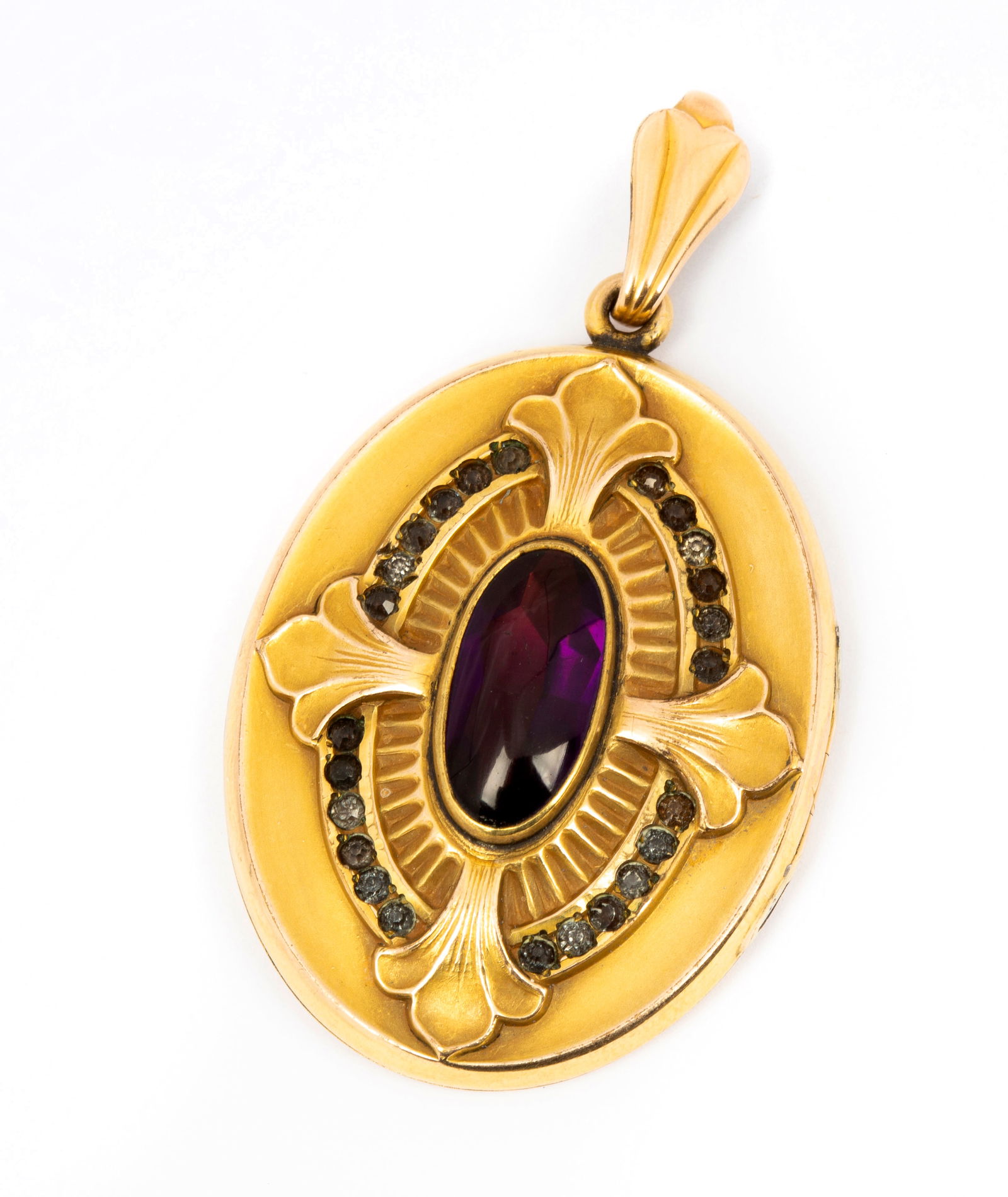 A Large Gold Filled and Paste Antique Locket: Marked inside "W&H Co", oversized oval locket with center oval purple cabochon with faceted underside with fluted border and halo of paste, large bail to accommodate a variety of chains, locket does n