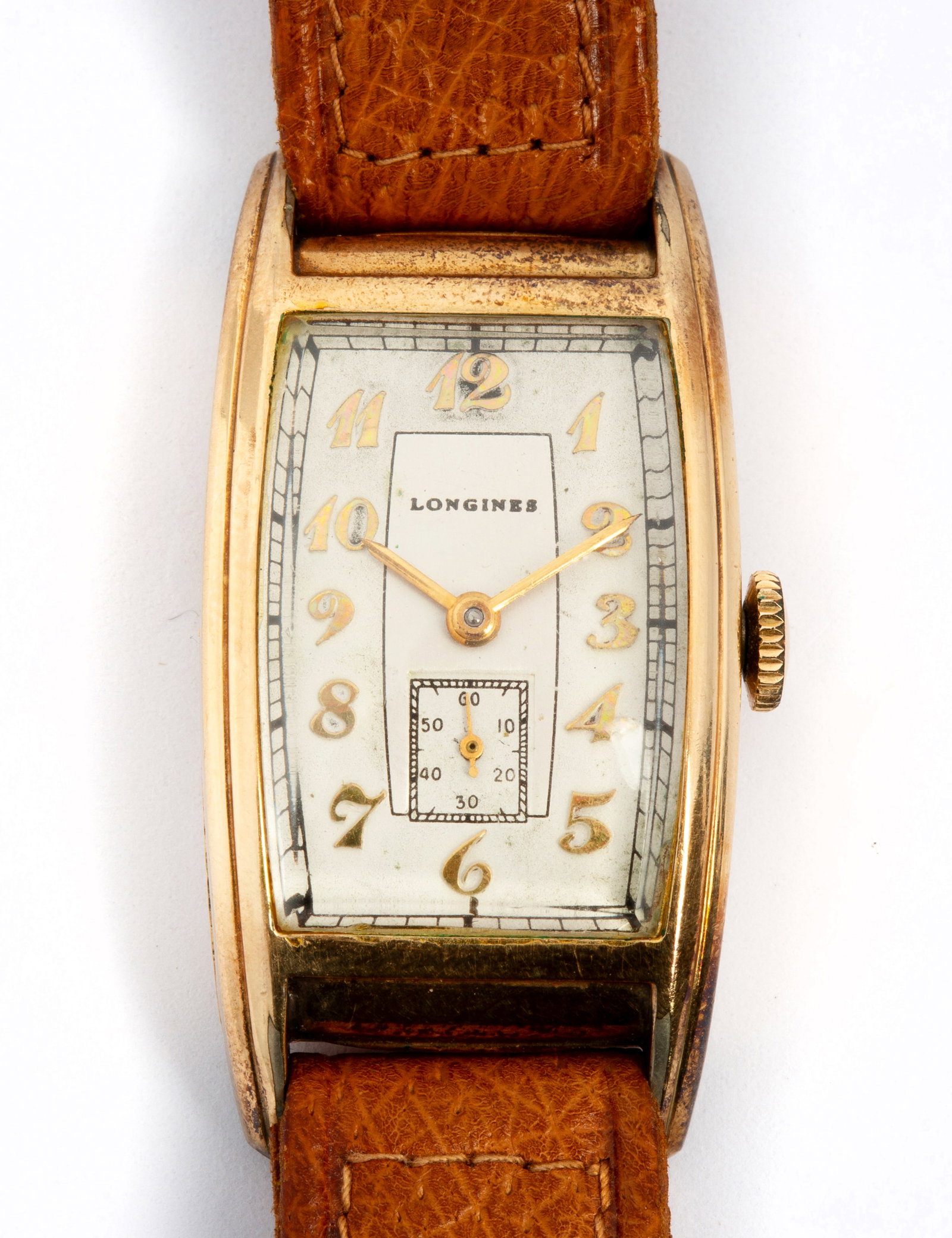 A Longines Tonneau Wristwatch, 1937: Curved rectangular tonneau-shaped gold filled case, gilt hands and stylized arabic numerals, small second hand dial, manual wind movement, 17 jewels, 9L caliber, 1937 serial number; inside of case mar