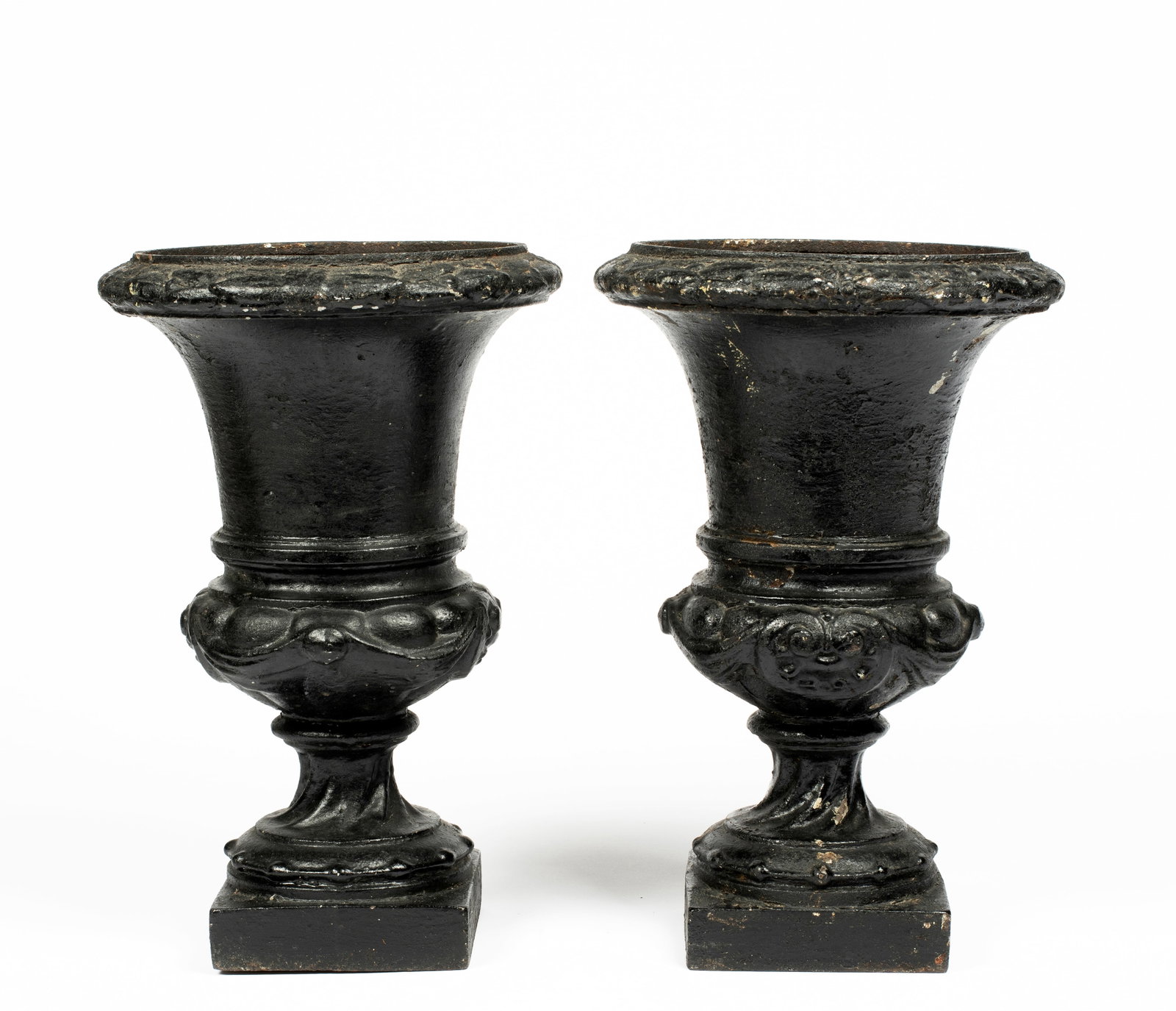 A Pair of Antique Cast Iron Campana Form Garden Urns: With neoclassical designs and black paint, on square bases, each 12" high, with & 7 3/4" diameter urns and 4 1/2" x 4 1/2" bases.