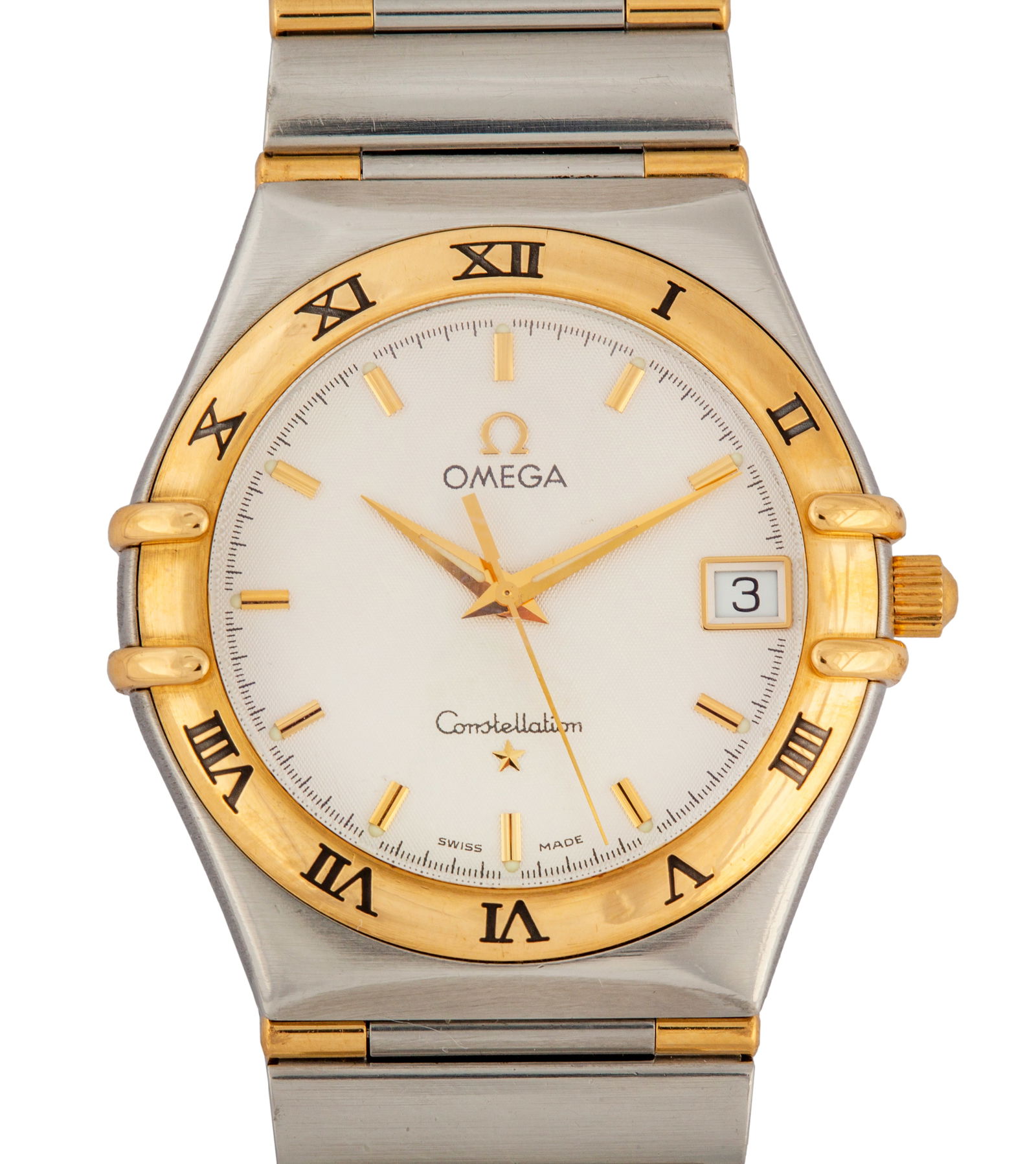 An Omega Constellation, 33.5mm, Quartz, Reference: 1312.30, 1998: 33.5mm steel case with gold bezel, case claws and crown, and sapphire crystal. Guilloche diamond pattern dial with gold markers, dauphine hands, and date window. Integrated steel and 'half bar' gold b