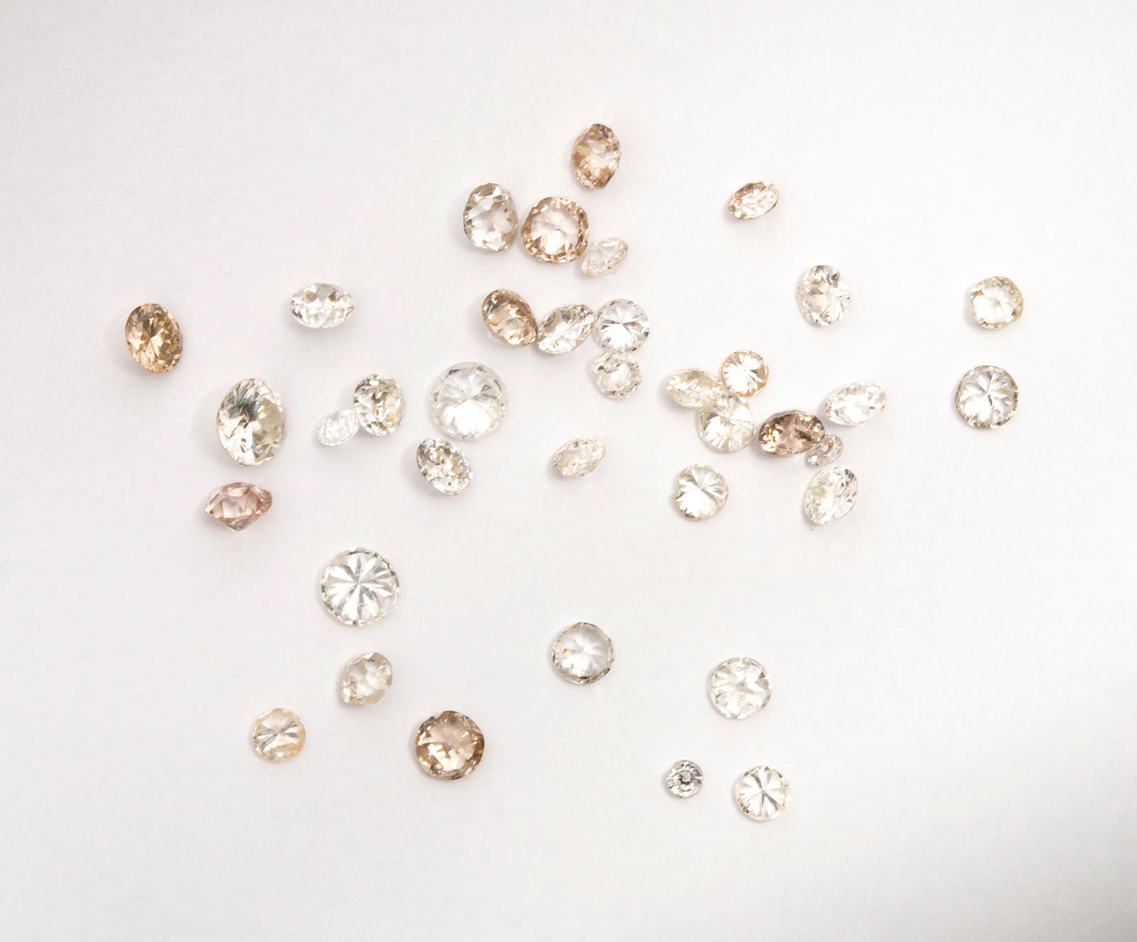 A Large Lot of Loose Diamonds 3 TCW: Thirty-seven diamonds ranging from 1.6 mm to 3.8 mm, round and irregular cut stones, some chips visible, weighed at a total of 3 carats.