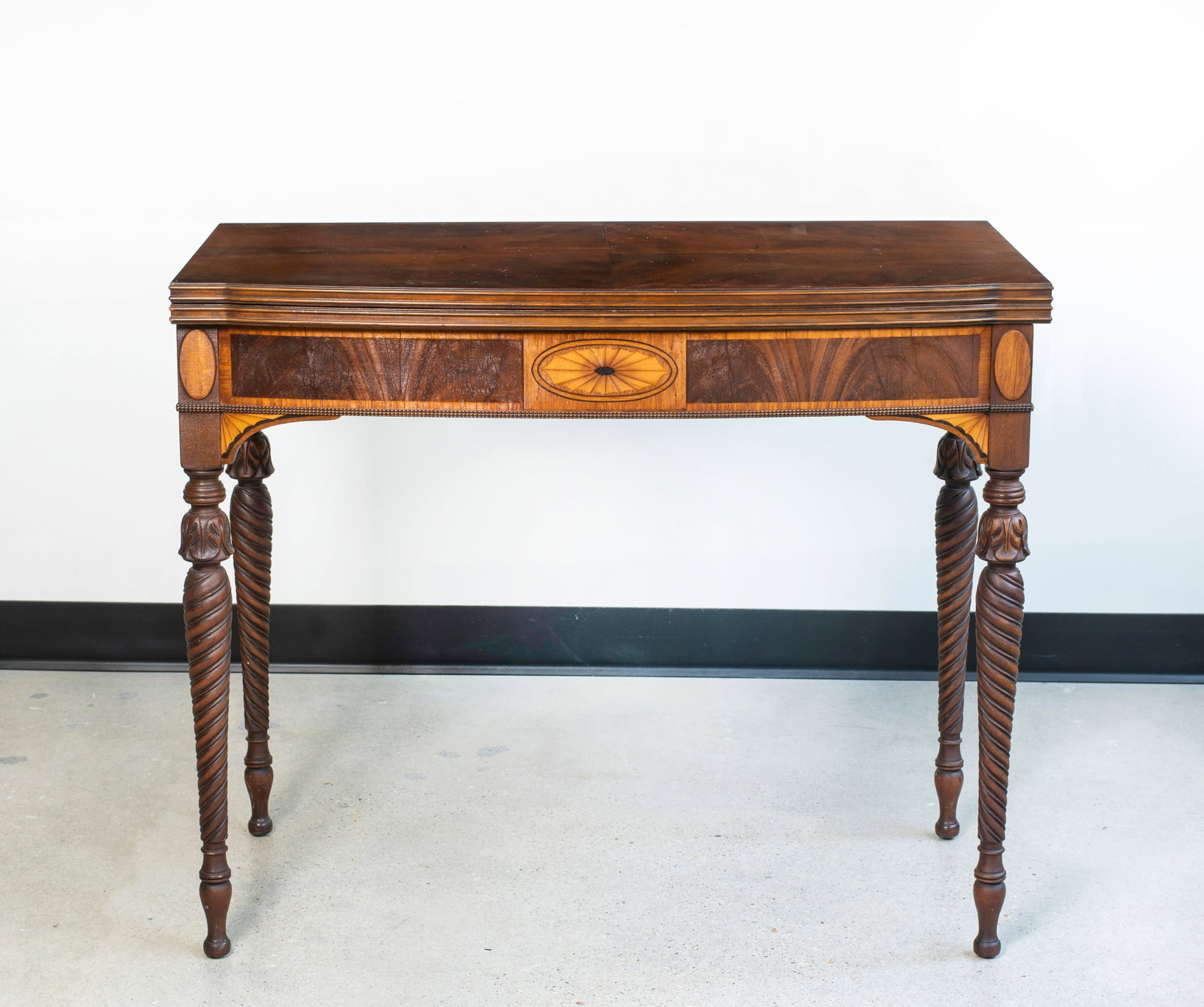 An Inlaid Card Table: Swivel top card table with front inlaid decoration over tapered spiral fluted legs, some wear to finish from age and use, 37" tall x 37" wide x 19" deep folded and 37 7/8" open, pr