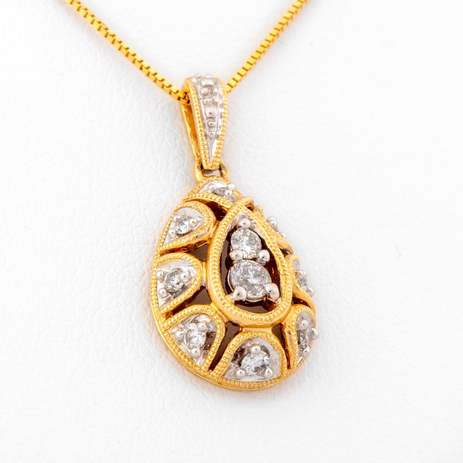 Diamond and 14K Gold Teardrop Necklace: Marked on back of pendant, "14K, AJ, 4761, 1/4", teardrop pendant with total drop of 13/16" with delicate milgrain edged and a larger and smaller diamond in the center and pierced borde