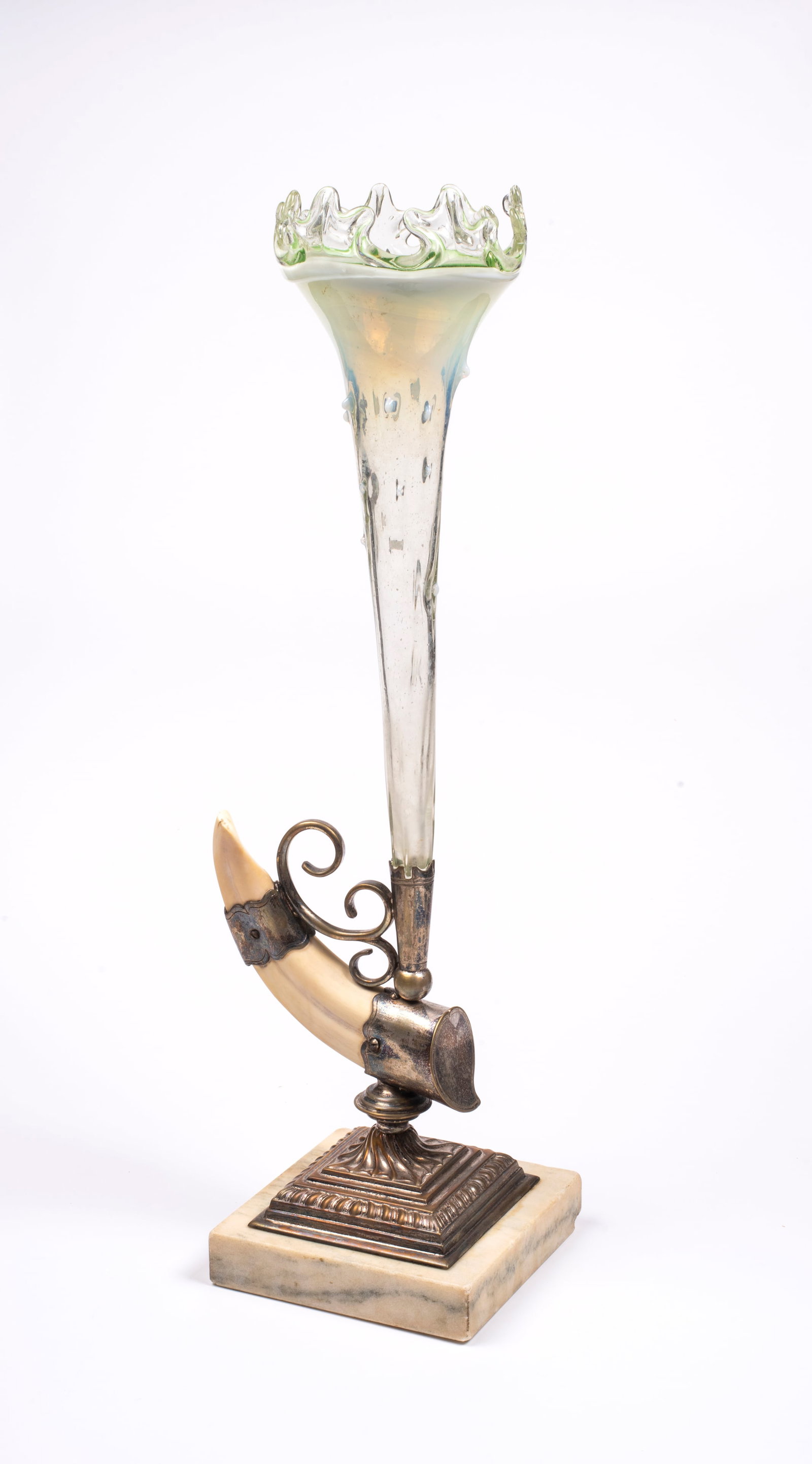 Antique Art Glass Eperne: Unmarked, clear to light green glass with ruffled rim (one chip noted), set into silver plated base with bone accent terminating with a square marble base (some loss), 17" tall. 