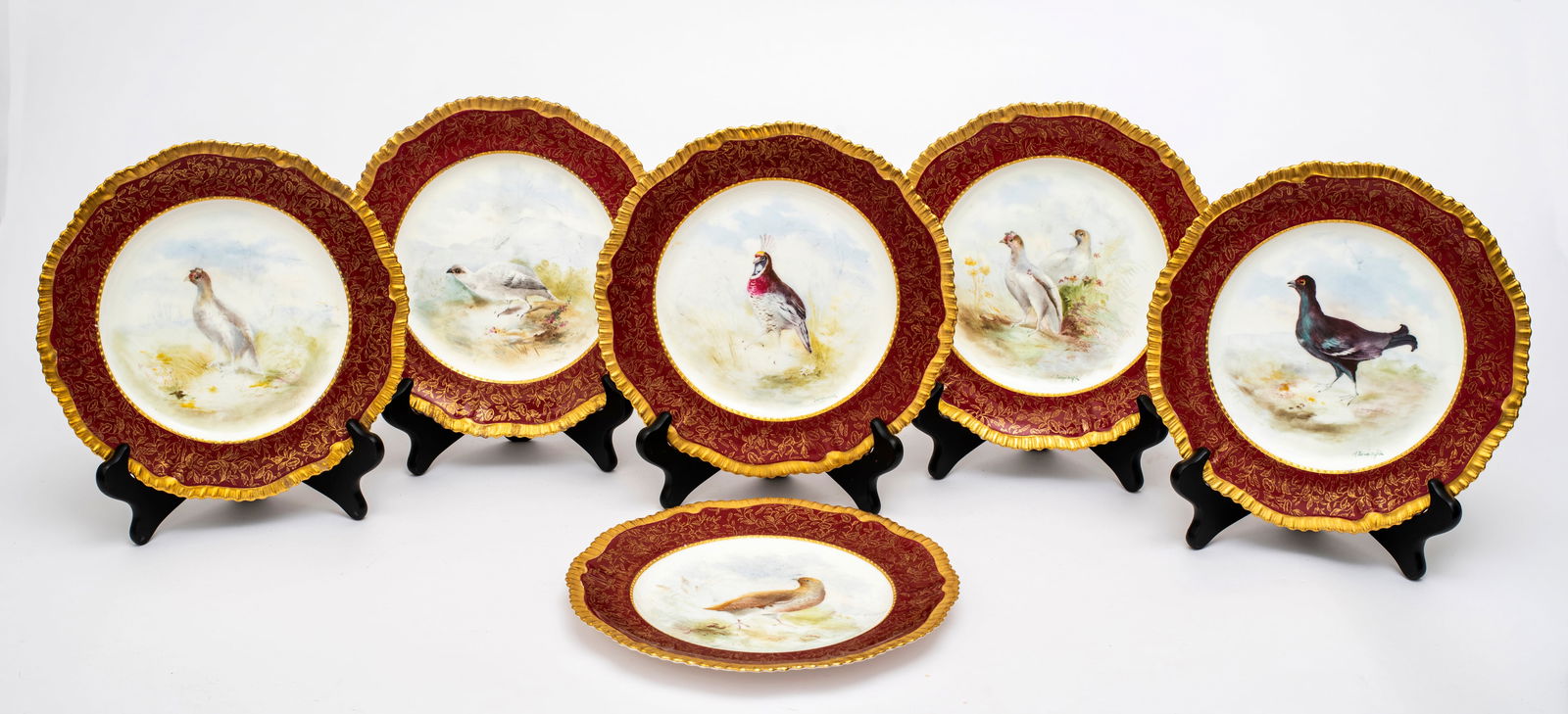Six Ovington Brothers Gild and Painted Bird Plates: Marked on the bottom with stamp, "Ovington Brothers, New York, H & Co England" along with impressed stamp and the name of each bird pictured, six unique birds all hand painted with burgu