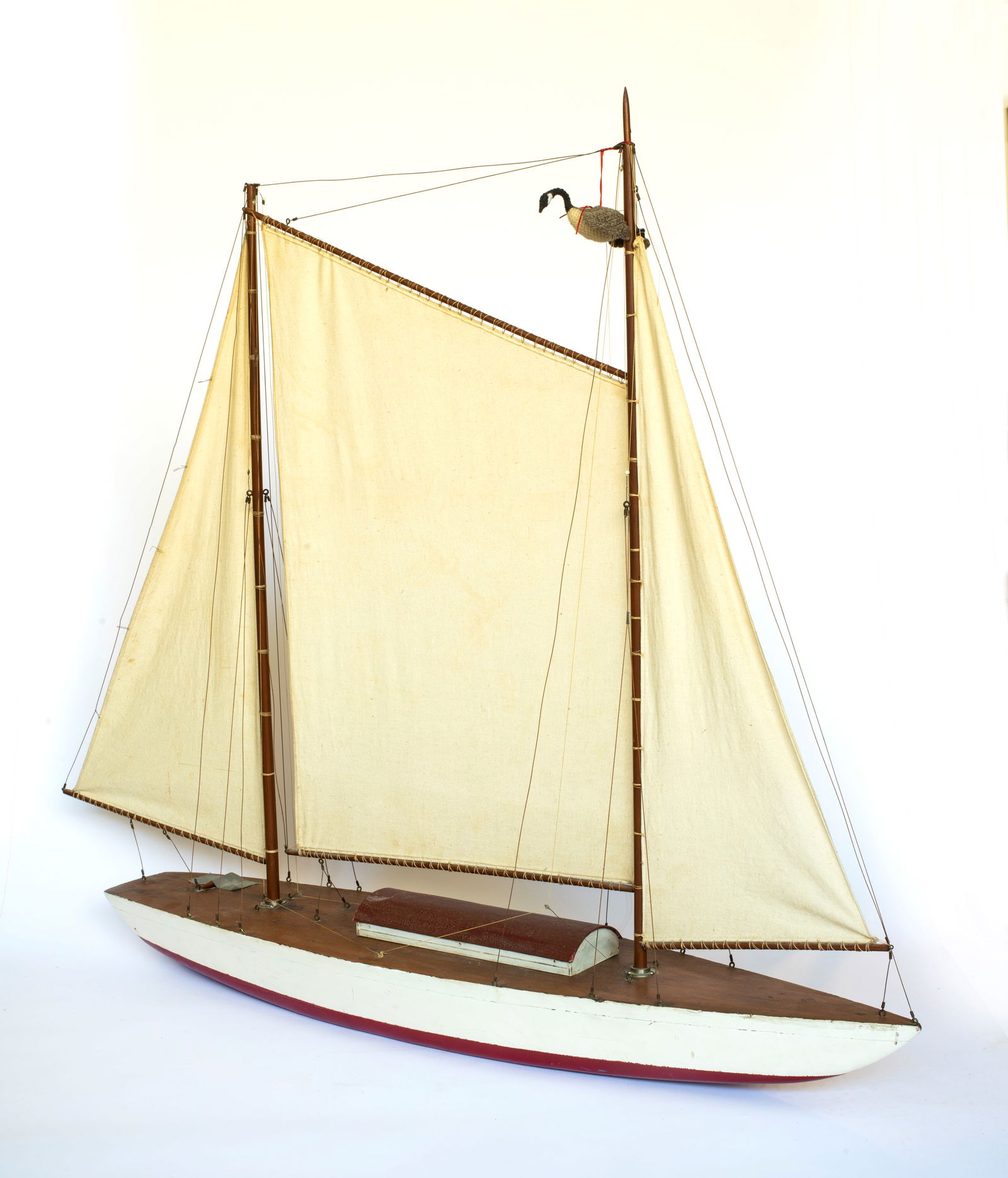 A Vintage Pond Model: Apparently unsigned, old white and red paint with wood top and painted cabin cover, flat bottom, wooden masts and cotton sails, the top of one mast is broken off but included for repair, some wear to