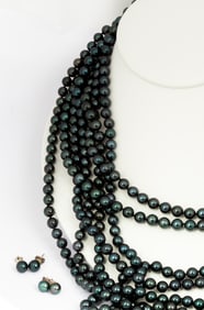 A Seven Strand Dark Pearl Necklace and Two Pairs of Earrings