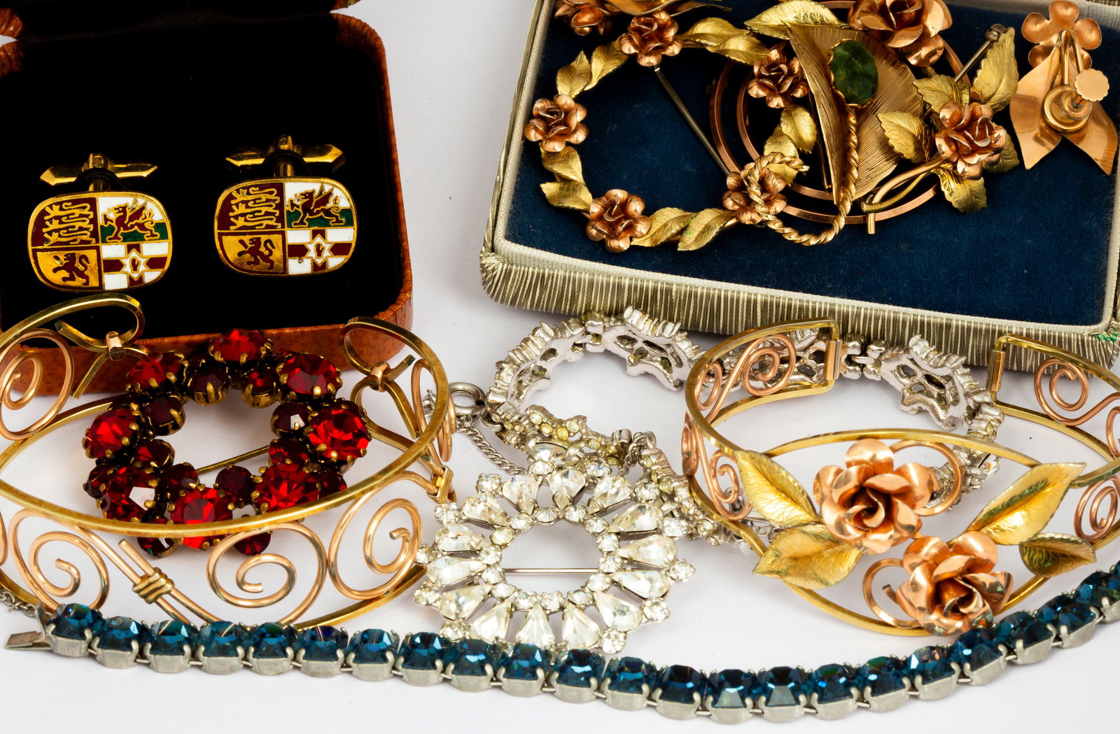 A Group of Krementz and Costume Jewelry: Includes: Two Krementz cuff bracelets, one pair Krementz screw back earrings, and three Krementz brooches, one in box; a pair of gold tone Harvard cufflinks in box; four pieces rhinestone jewelry