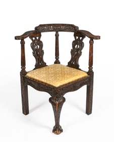 An Antique English Carved Oak Upholstered Corner Chair