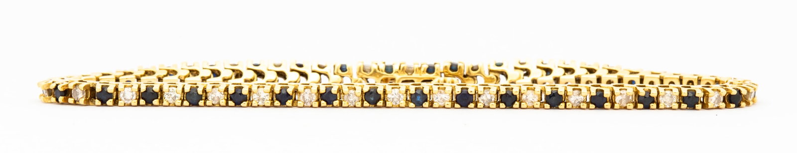 A Vintage 14K Sapphire and Diamond Tennis Bracelet: Marked 14k on clasp safety, alternating diamonds and sapphires, each approx. 2mm and set in four prongs, 7" long and a total weight of 9.4 grams. 