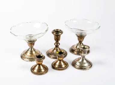 A Group of Sterling Weighted Candle Holders