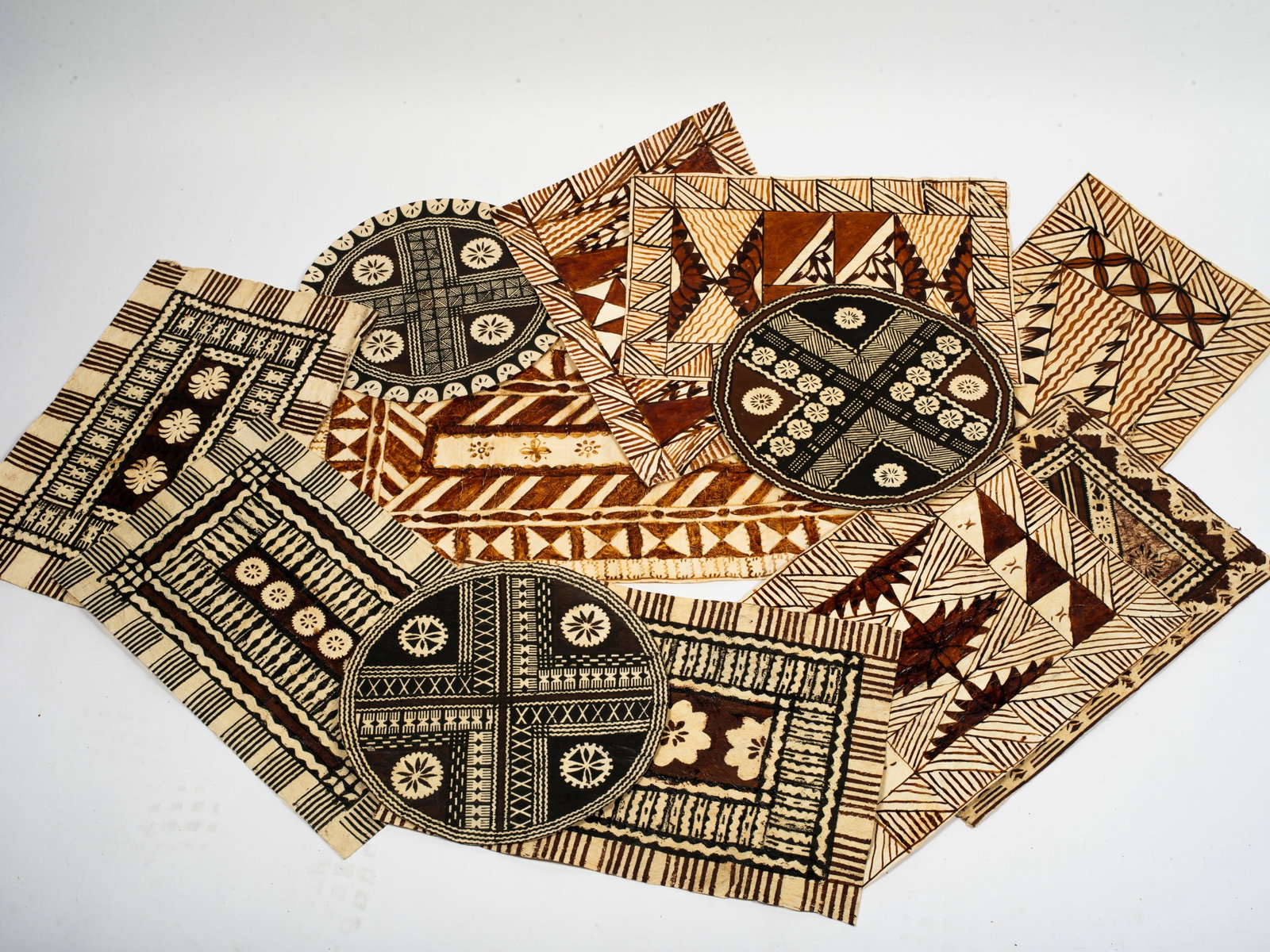 A Collection of Polynesian Decorative Tapa Cloths; Fiji, Tonga, Samoa: Twelve pieces in total, three circular and nine rectangle, from 13" to 29". Purchased in Auckland, New Zealand in 1973.