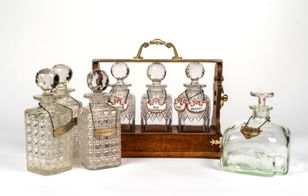 A Betjemann's Tantulus along with A Collection of Decanters and Sterling Tags