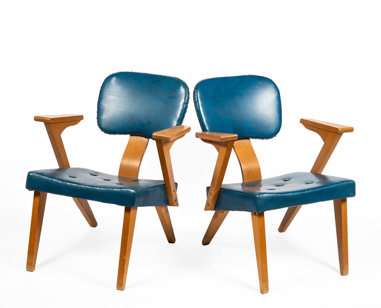 A Pair of Blue Mid Century Custom & Modern Upholstery Company, Gardner, MA, Chairs: Unmarked but identical to the grey pair with a label reading, "Custom & Modern Upholstery Company, Gardner, MASS", in blue vinyl with tacks around the back support, blonde wood with bent wood back sup