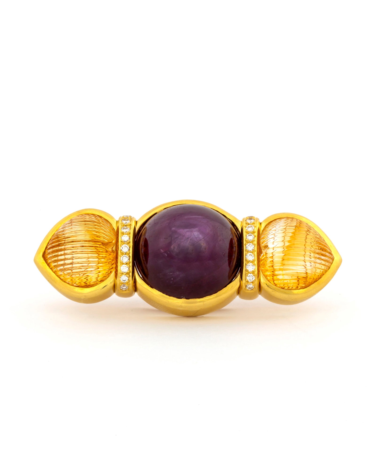 A Tambetti Massive Star Ruby and Citrine 18K Gold Brooch: Marked, "Tambetti, 18K", massive star ruby weighing approx. 56 carats flanked by diamonds and specialty cut fluted heart shaped citrines, measures approx. 2" x 1" with a total weight of 40.8 grams. Pr