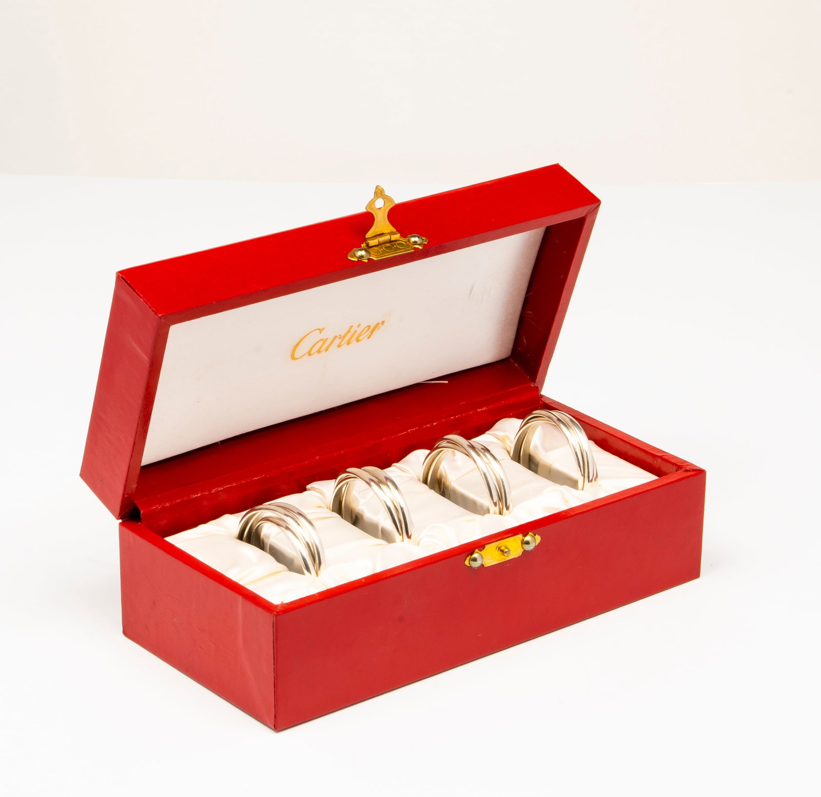 A Set of Four Cartier Sterling Silver Trinity Napkin Rings, with Original Box (1 of 9)