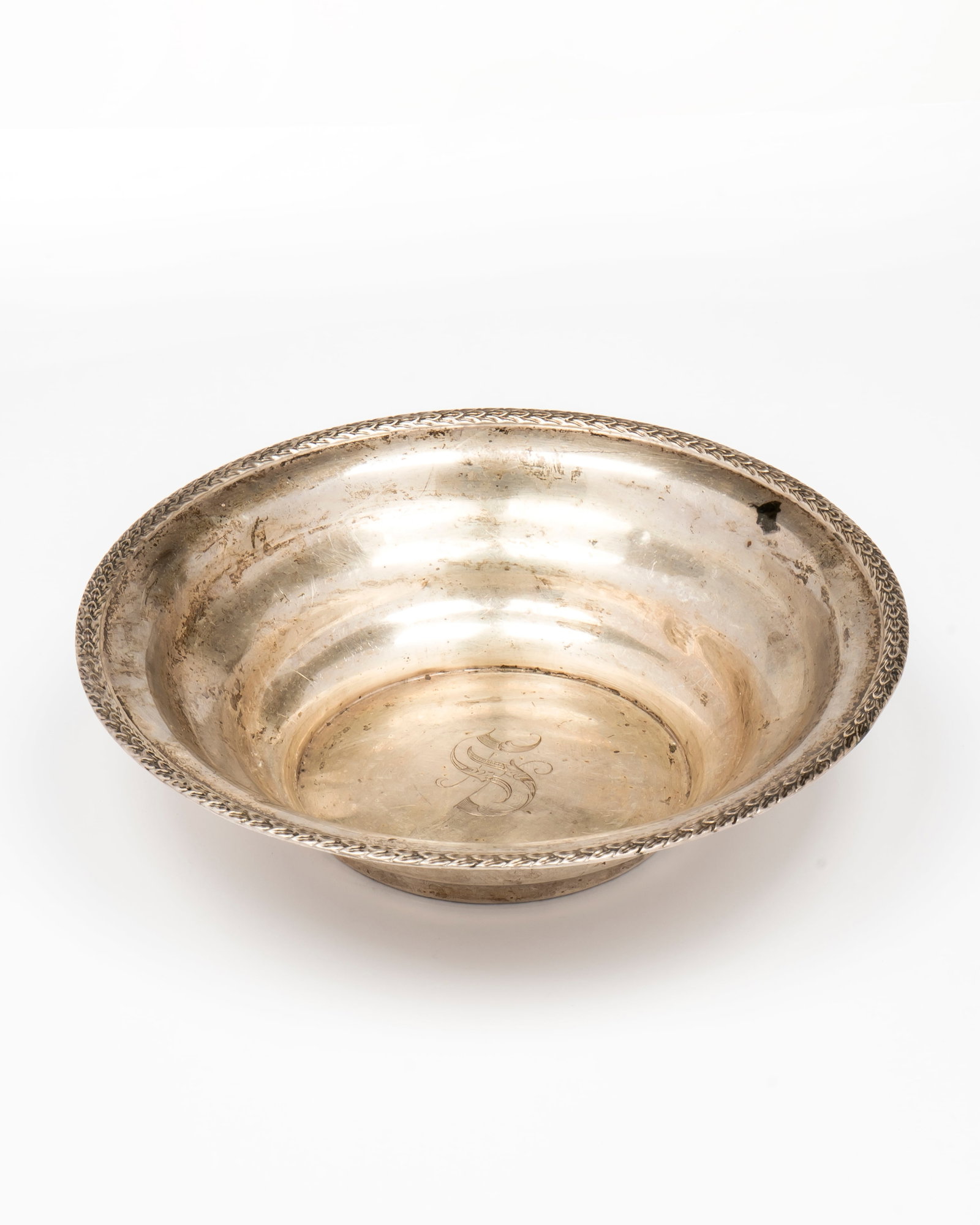 A Chicago Silver Company Sterling Silver Bowl: Marked on the bottom, "Sterling, C.S.Co, 372" with lobed side walls and a laurel leaf decorated rim, the center with a large "S" engraved, 8 3/8" diameter, 2 1/8" tall and a total weight of 7.8 Toz