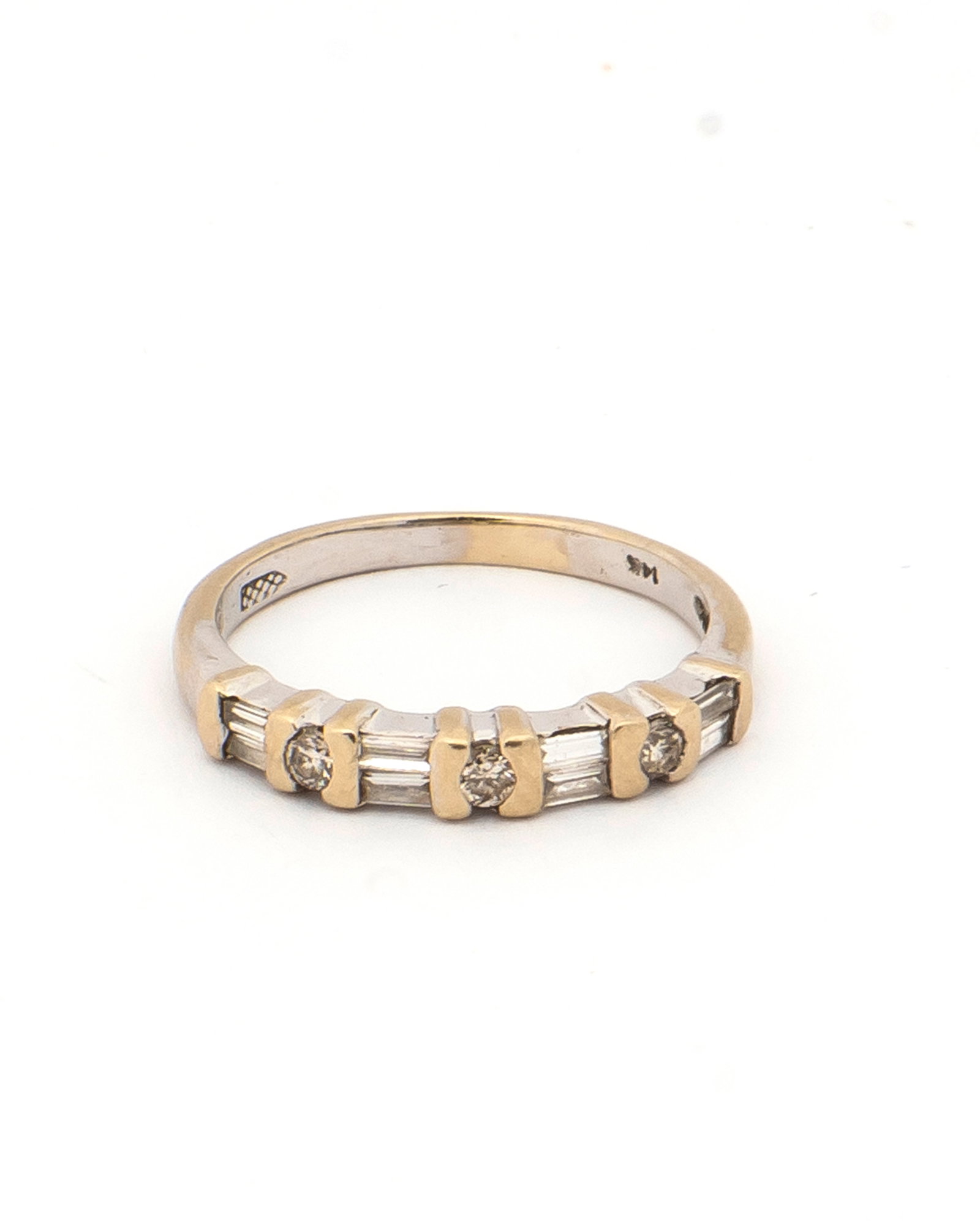 A Diamond and 14K White Gold Band: Marked, "14K", three small round diamonds each bar set alternating with four sections of double baguette diamonds also bar set, white gold, a ring size of 3 1/2 and a total weight of 1.3 grams.