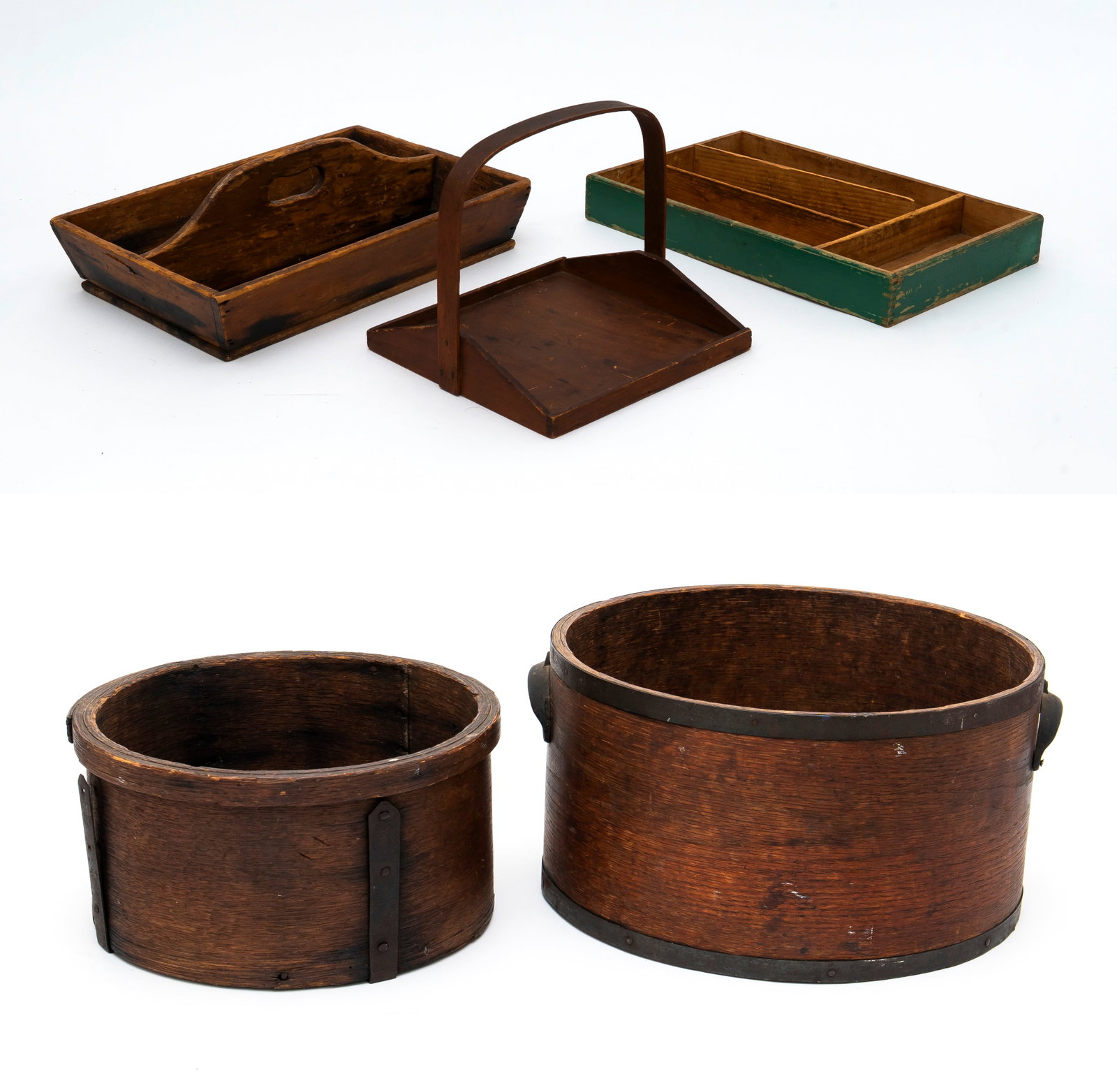 A Bentwood Dry Grain Measure by Daniel Cragin, Wilton, NH, and Four Other Primitive Pieces: The bentwood measure with applied metal rim, base and handles, marked on inside of bottom, diameter 14 1/2". Along with a primitive unmarked grain measure, diameter 12" and three wooden trays.