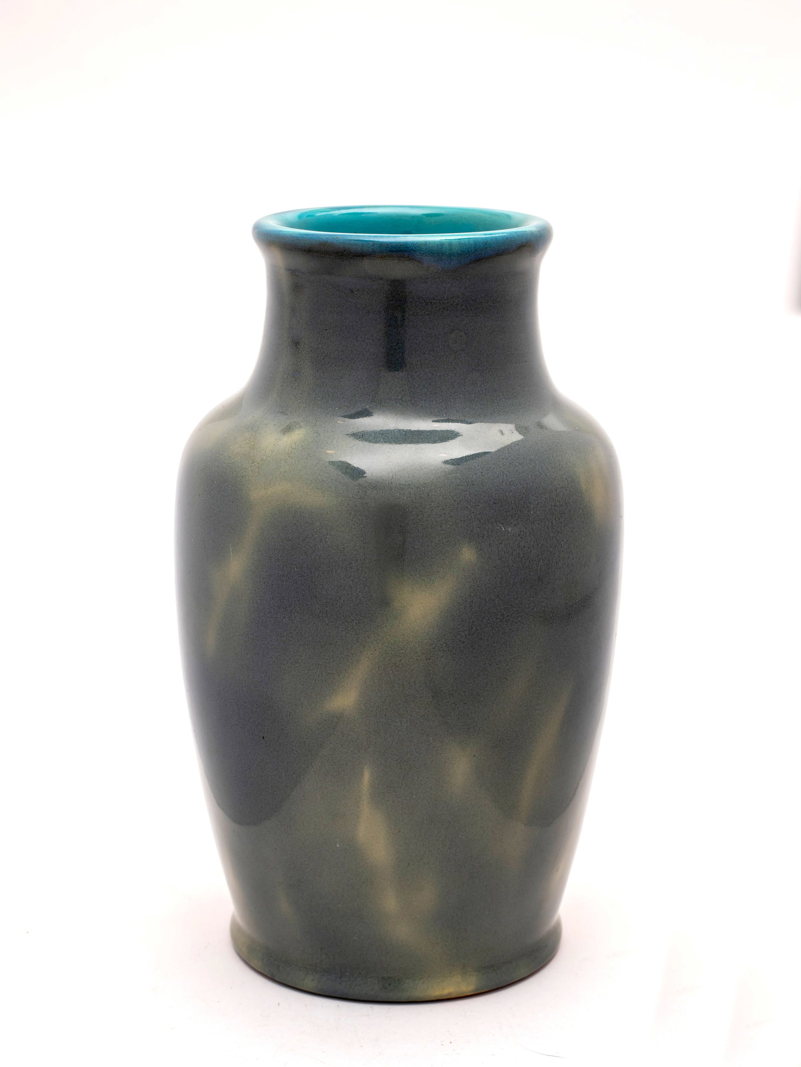 A California Faience Pottery Vase in Light Blue Glaze, c.1920: Multi-tone blue green glaze, with incised signature on the underside; height 9 1/4".