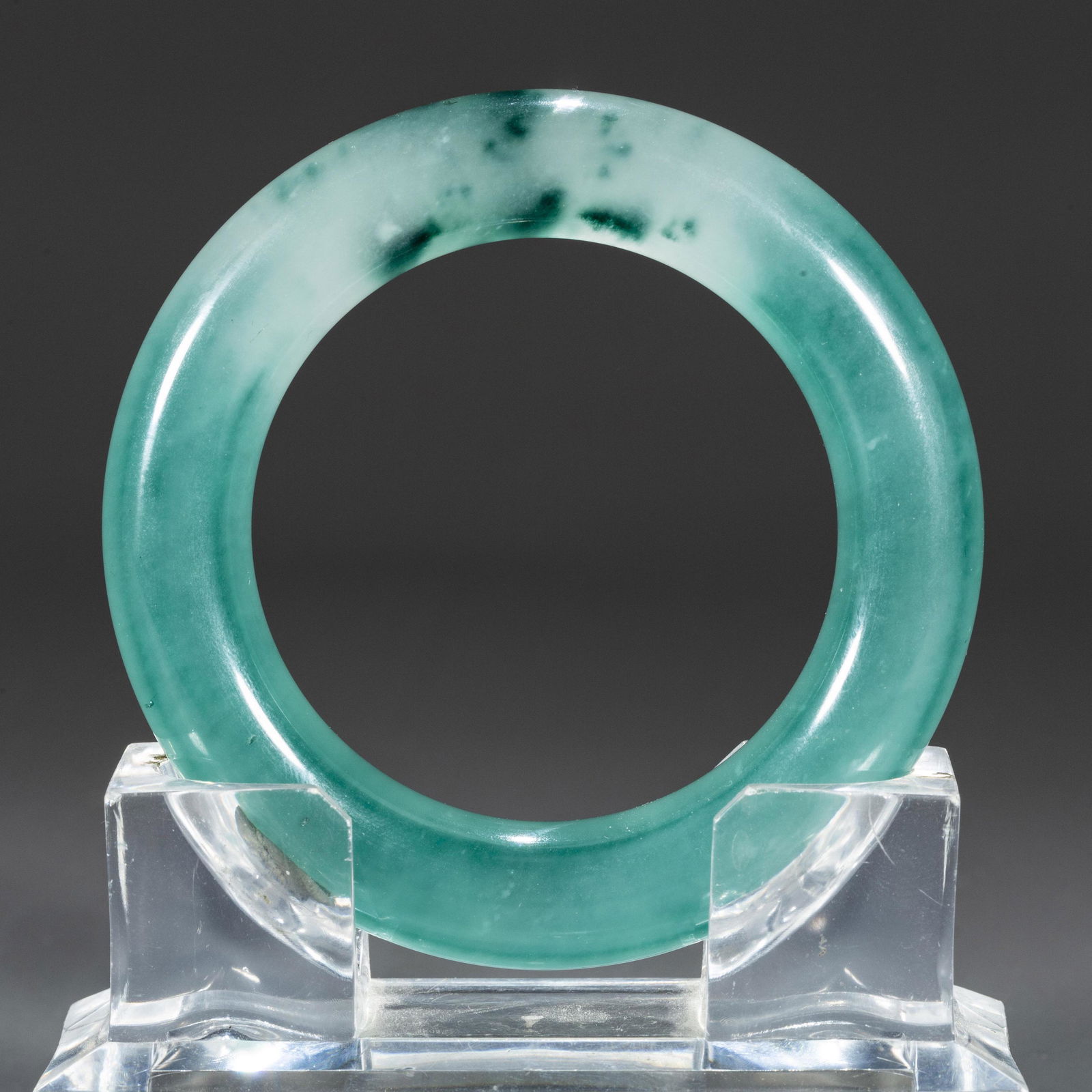 A JADEITE BANGLE.: Jadeite Bangle.