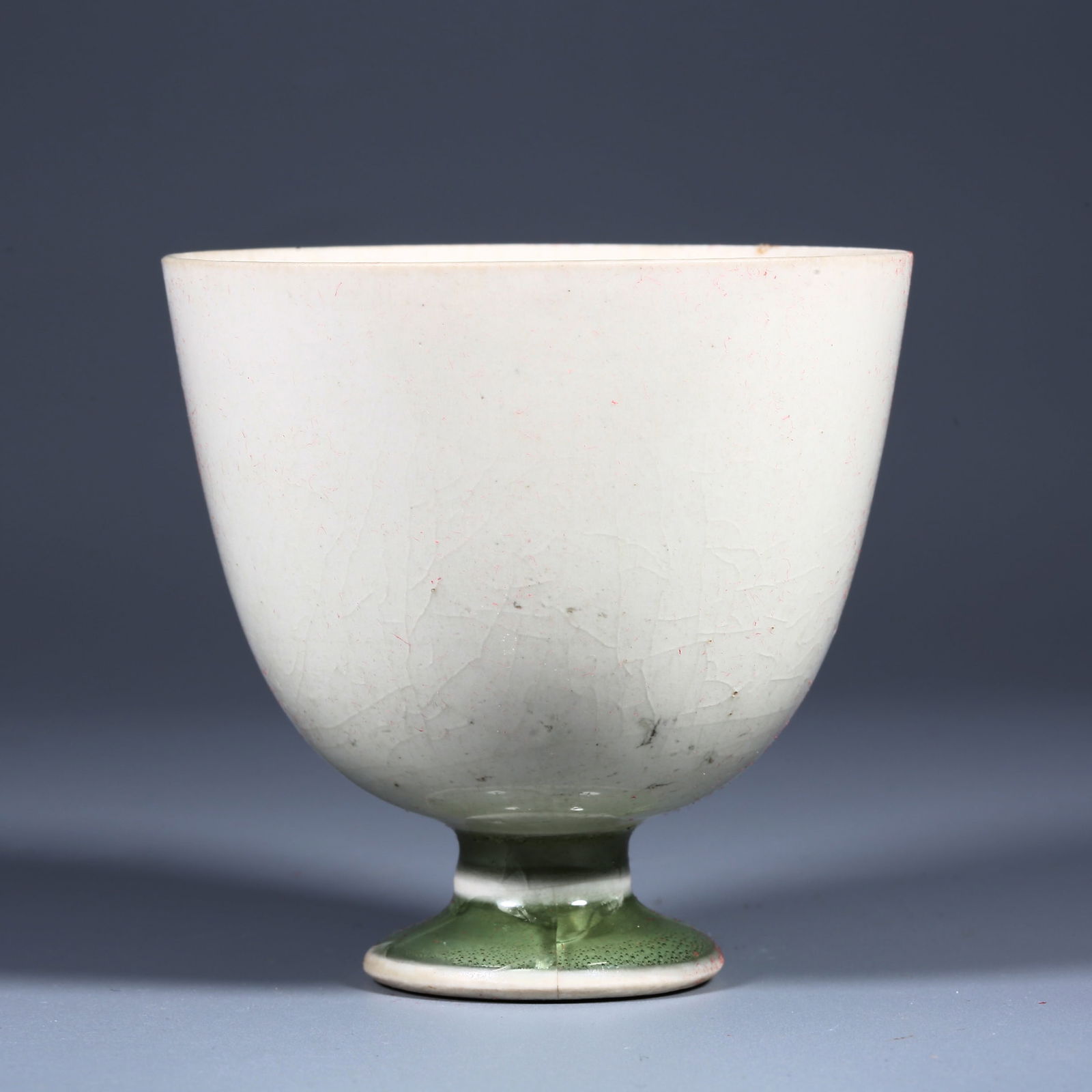 A CELADON CUP WITH TALL HOLDER.: Celadon Cup with Tall Holder.