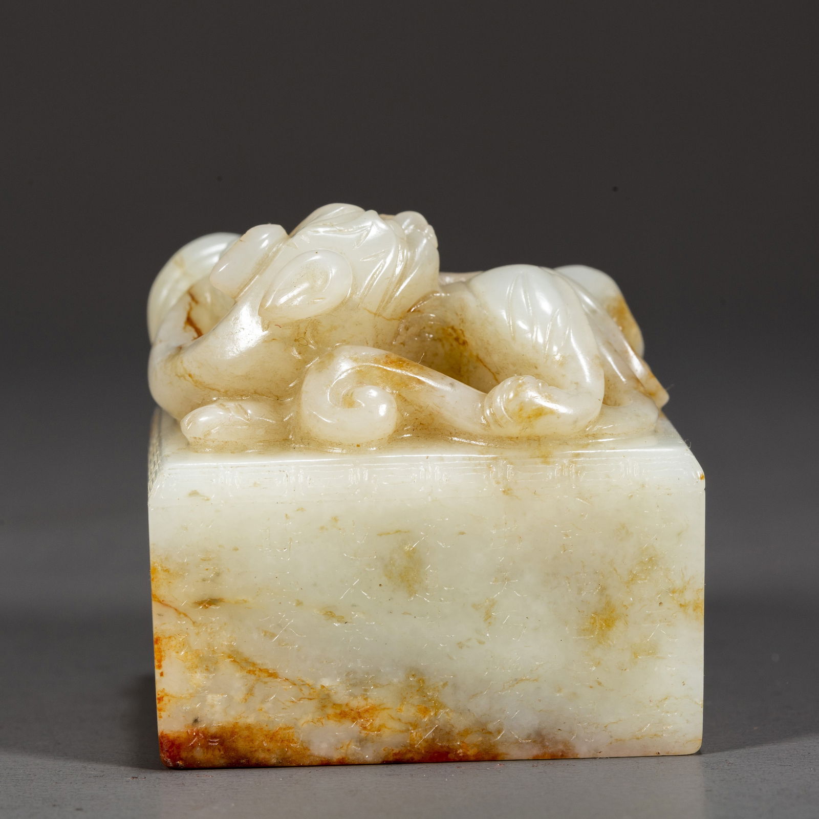A HETIAN WHITE JADE DRAGON-KNOB SEAL. (1 of 6)