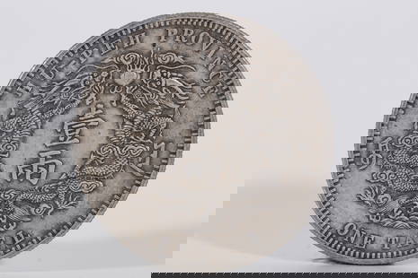 A SILVER DOLLAR COIN: One silver dollar coin