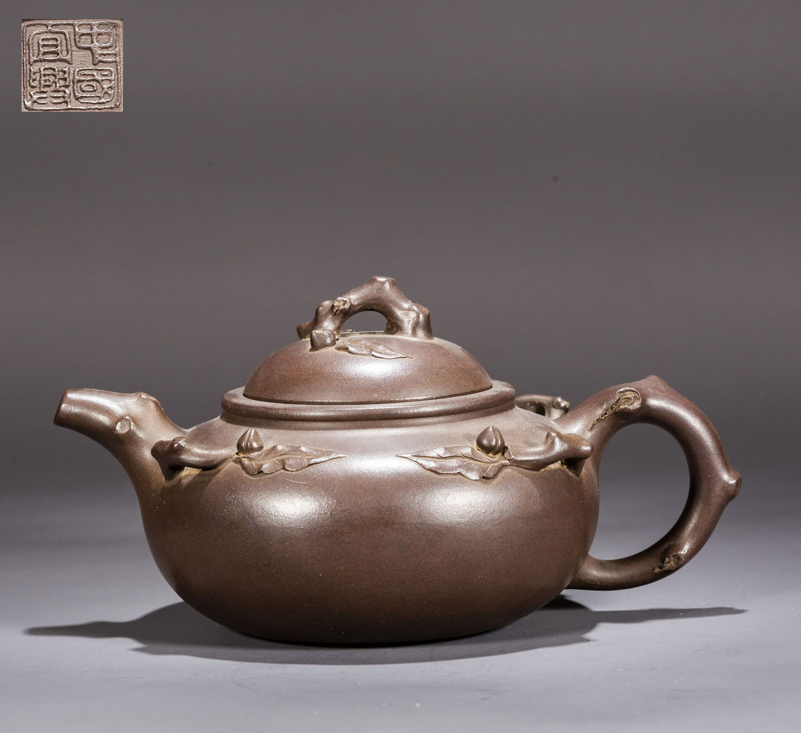 A PURPLE CLAY TEAPOT WITH PEACHES DESIGN. (1 of 8)