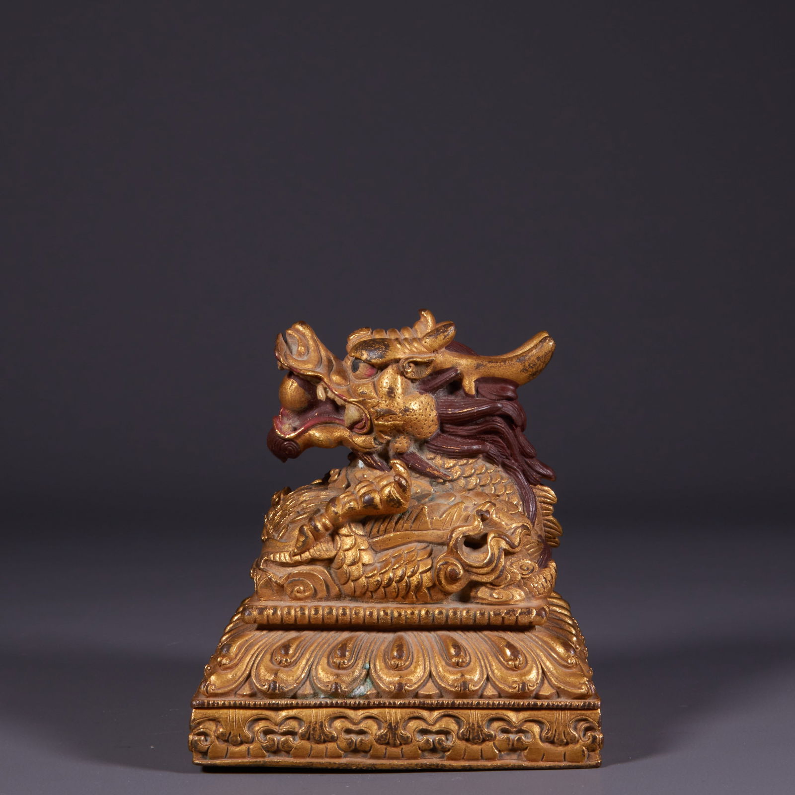 A GILT BRONZE SEAL WITH DRAGON-SHAPED KNOB. (1 of 7)