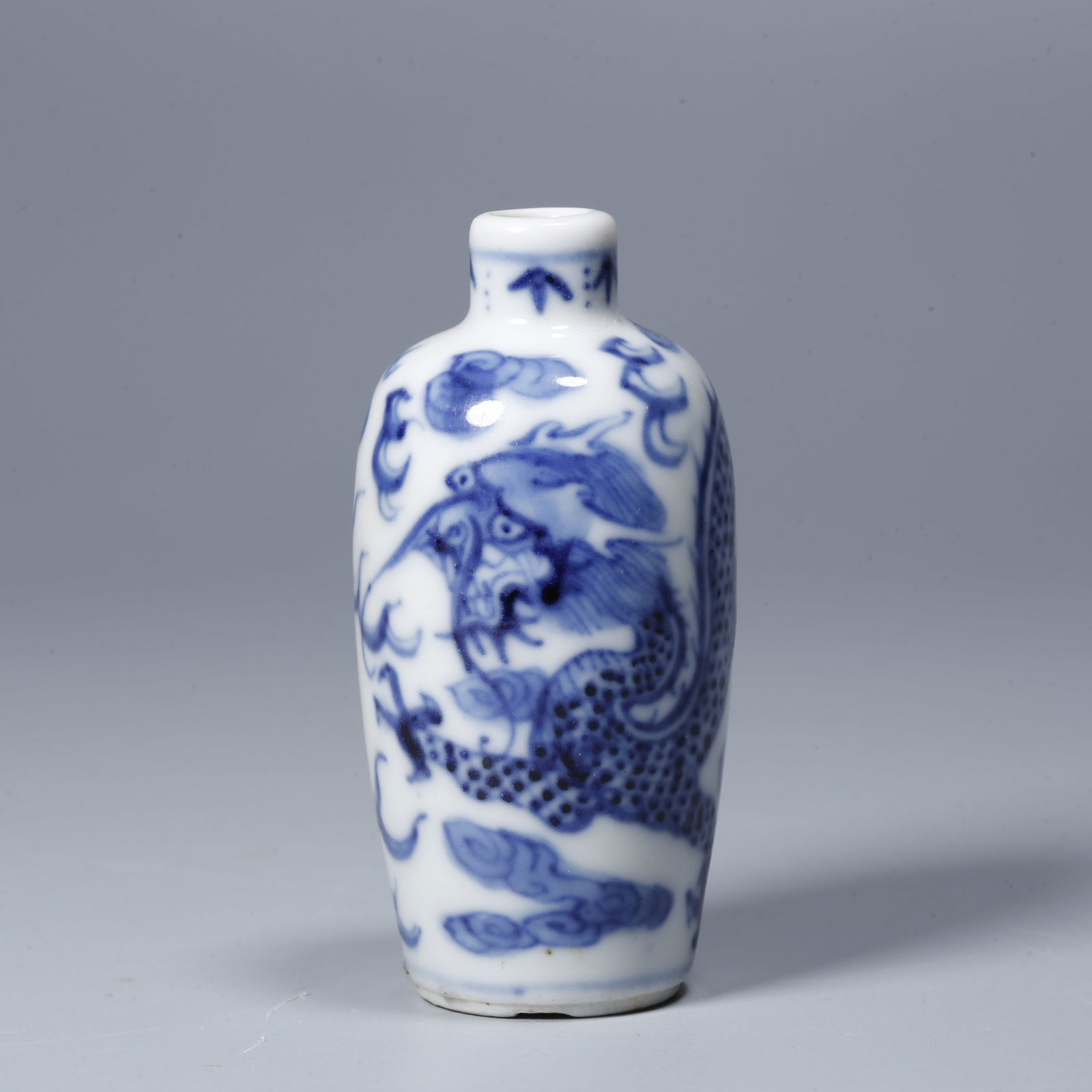 A BLUE AND WHITE SNUFF BOTTLE WITH CLOUD AND DRAGON DESIGN: Blue and White Snuff Bottle with Cloud and Dragon Design