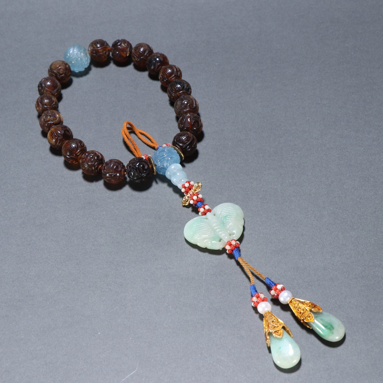 A AMBER EIGHTEEN-ARHAT HAND BEADS WITH SHOU SYMBOL, QING DYNASTY (1 of 9)