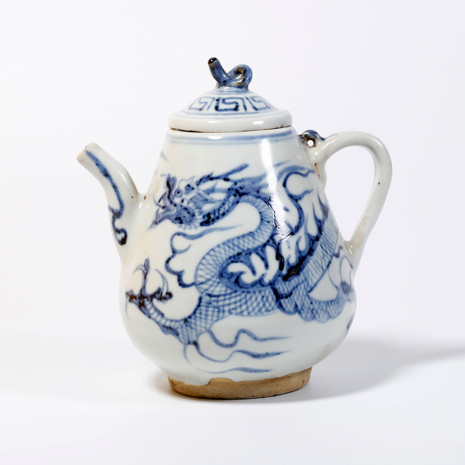 A BLUE AND WHITE EWER WITH CLOUD-AND-DRAGON MOTIF: Blue and white ewer with cloud-and-dragon motif