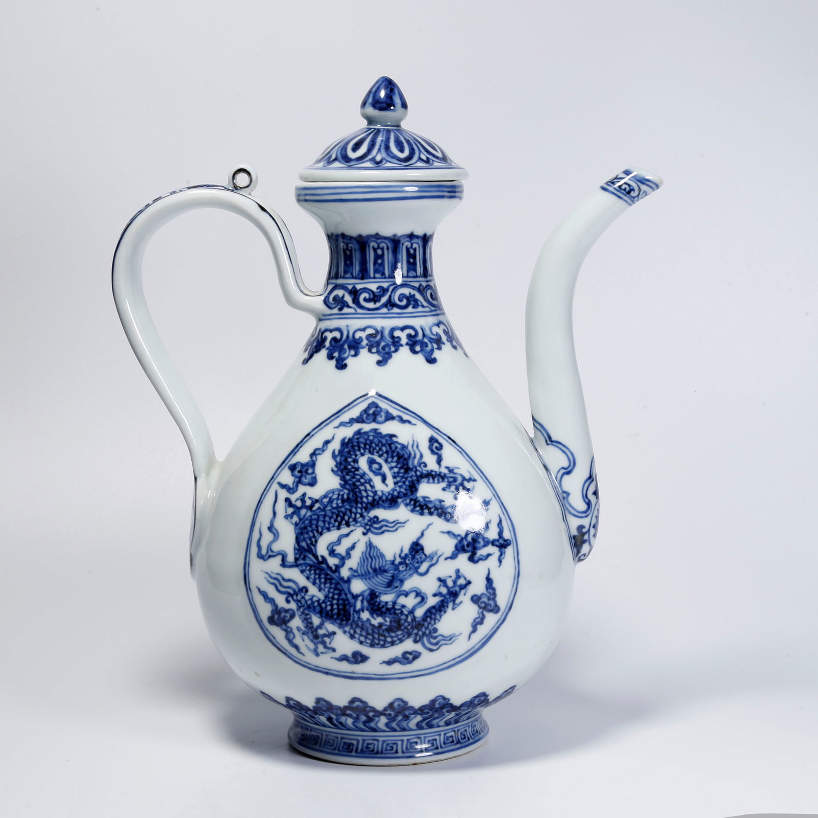 A BLUE AND WHITE CLOUD AND DRAGON PATTERN EWER: Blue and White Cloud and Dragon Pattern Ewer