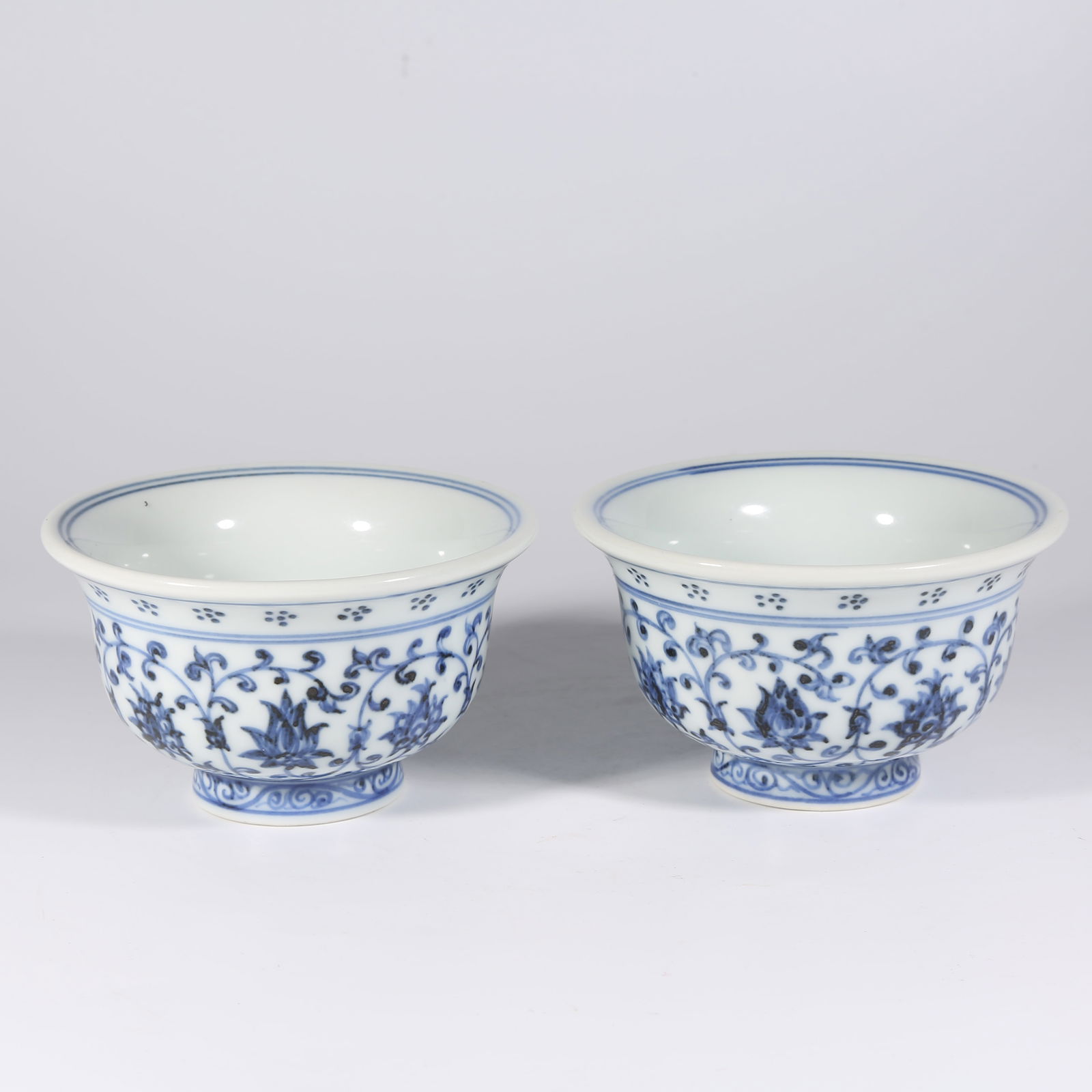 A SET OF BLUE-AND-WHITE CUPS WITH ENTWINED LOTUS DESIGN: Set of Blue-and-White Cups with Entwined Lotus Design