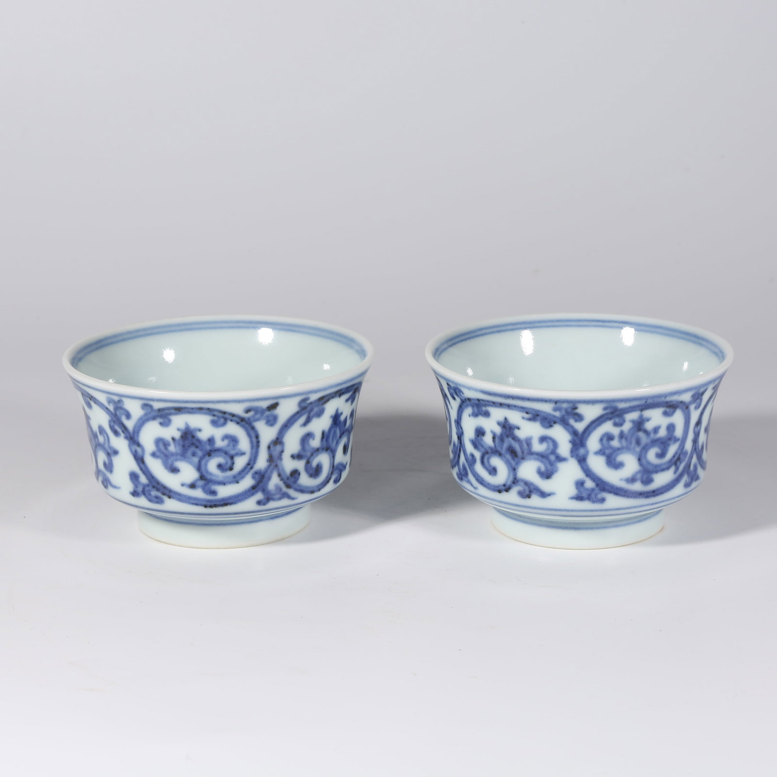 A SET OF BLUE-AND-WHITE CUPS WITH ENTWINED LOTUS DESIGN: Set of Blue-and-White Cups with Entwined Lotus Design