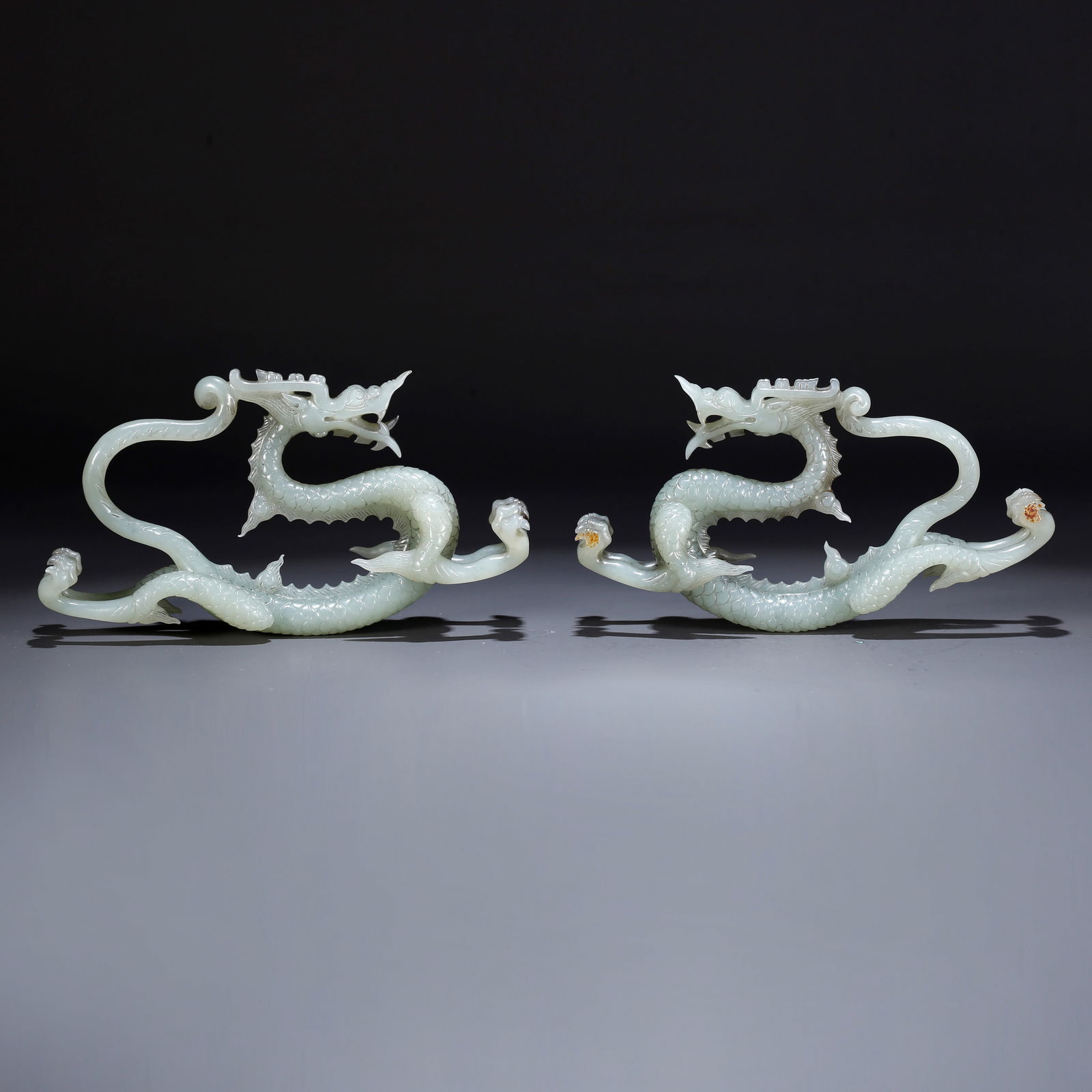 A HETIAN JADE CARVED PAIR OF CHILONG-SHAPED ORNAMENTS (1 of 10)