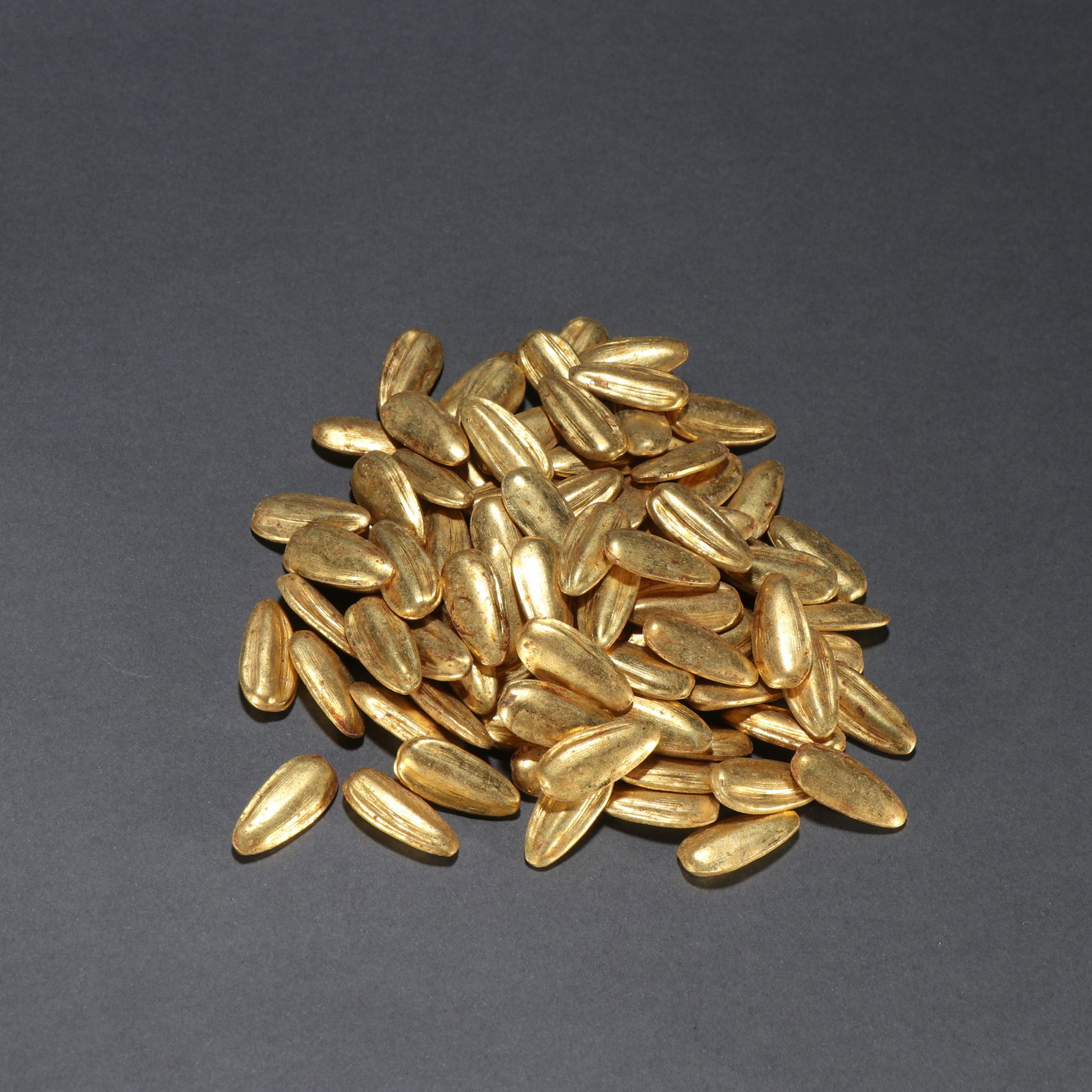 A GILT-BRONZE MELON SEED-SHAPED INGOTS (1 of 9)