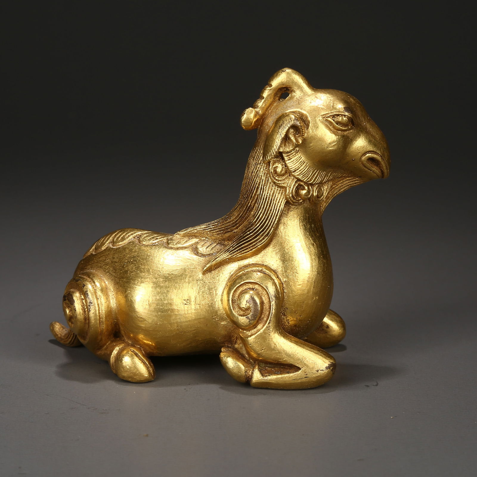 A GILDED BRONZE MYTHICAL BEAST PAPERWEIGHT: Gilded bronze mythical beast paperweight