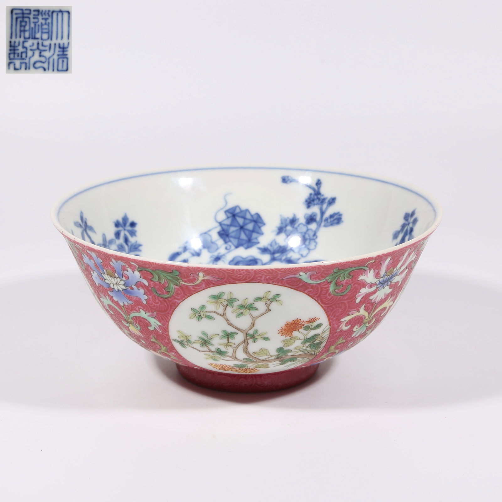 A RASPBERRY-RED GROUND FAMILLE ROSE WINDOWED FLORAL BOWL WITH DIAPER PATTERN: Raspberry-red Ground Famille Rose Windowed Floral Bowl with Diaper Pattern