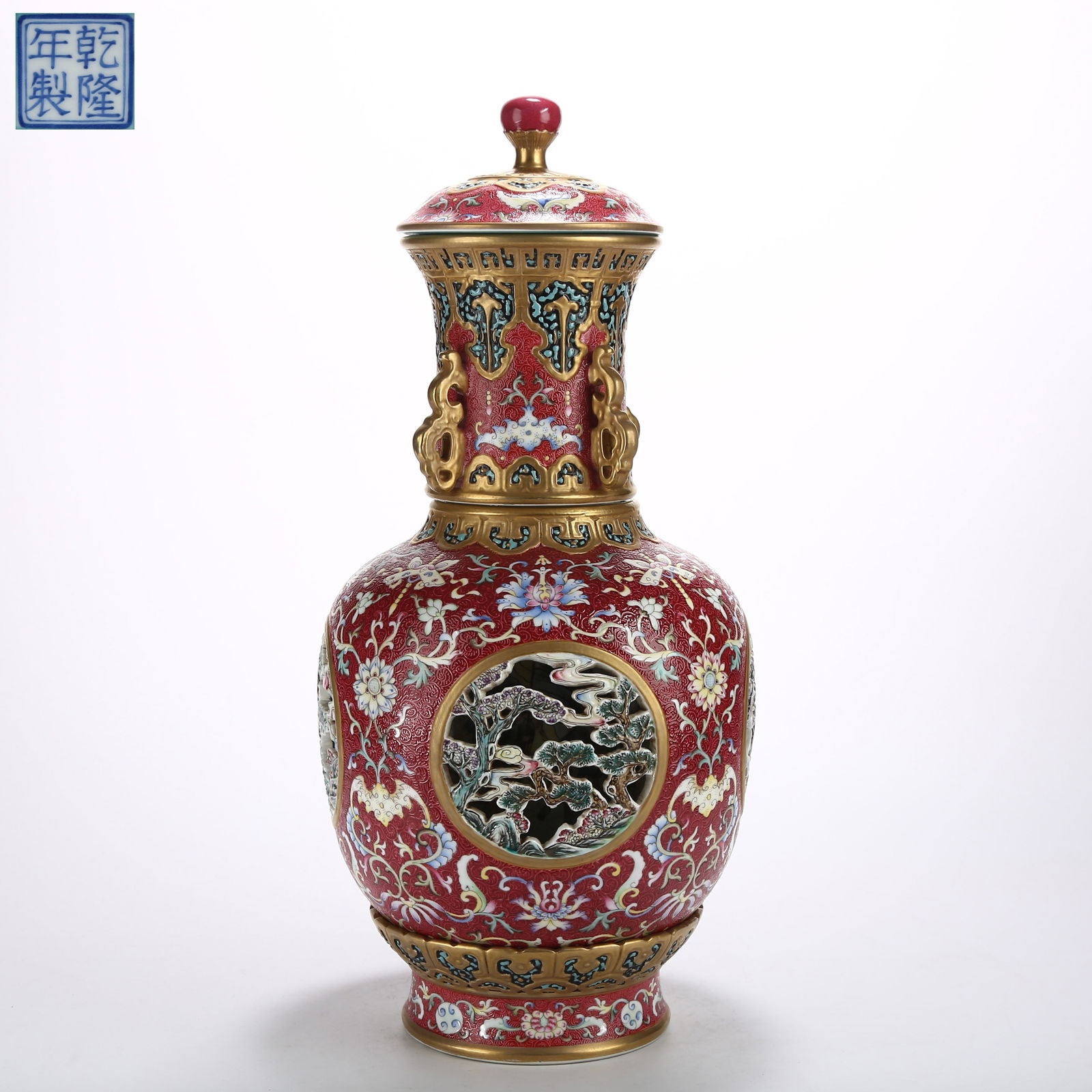 A ROSE-PINK GROUND RETICULATED FAMILLE ROSE VASE WITH WINDOWED LANDSCAPE AND REVOLVING CORE LID: Rose-Pink Ground Reticulated Famille Rose Vase with Windowed Landscape and Revolving Core Lid