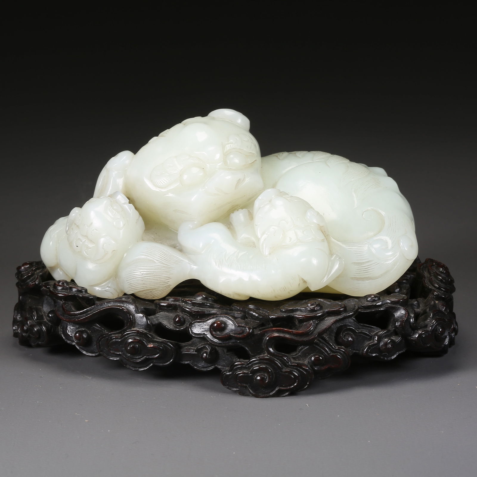 A HETIAN WHITE JADE PAIR OF ADULT AND YOUNG LION ORNAMENTS: Hetian white jade pair of adult and young lion ornaments