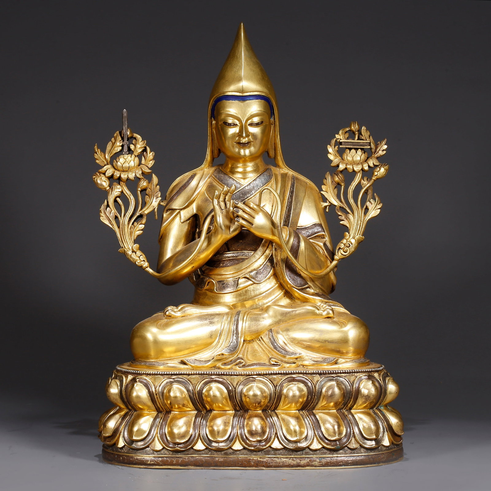 A GILT BRONZE STATUE OF A LAMA: Gilt Bronze Statue of a Lama