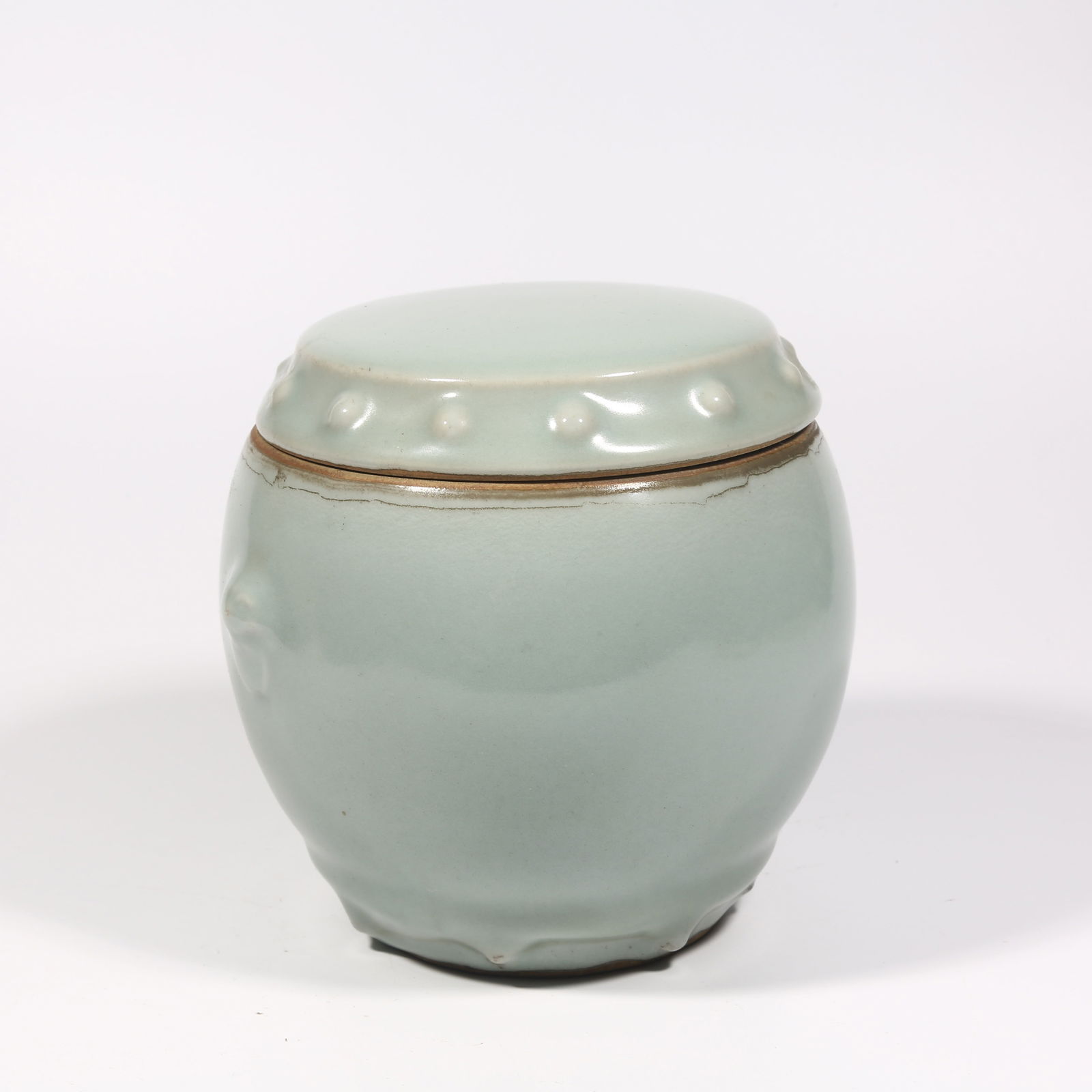 A LONGQUAN KILN DRUM-SHAPED LIDDED JAR: Longquan kiln drum-shaped lidded jar